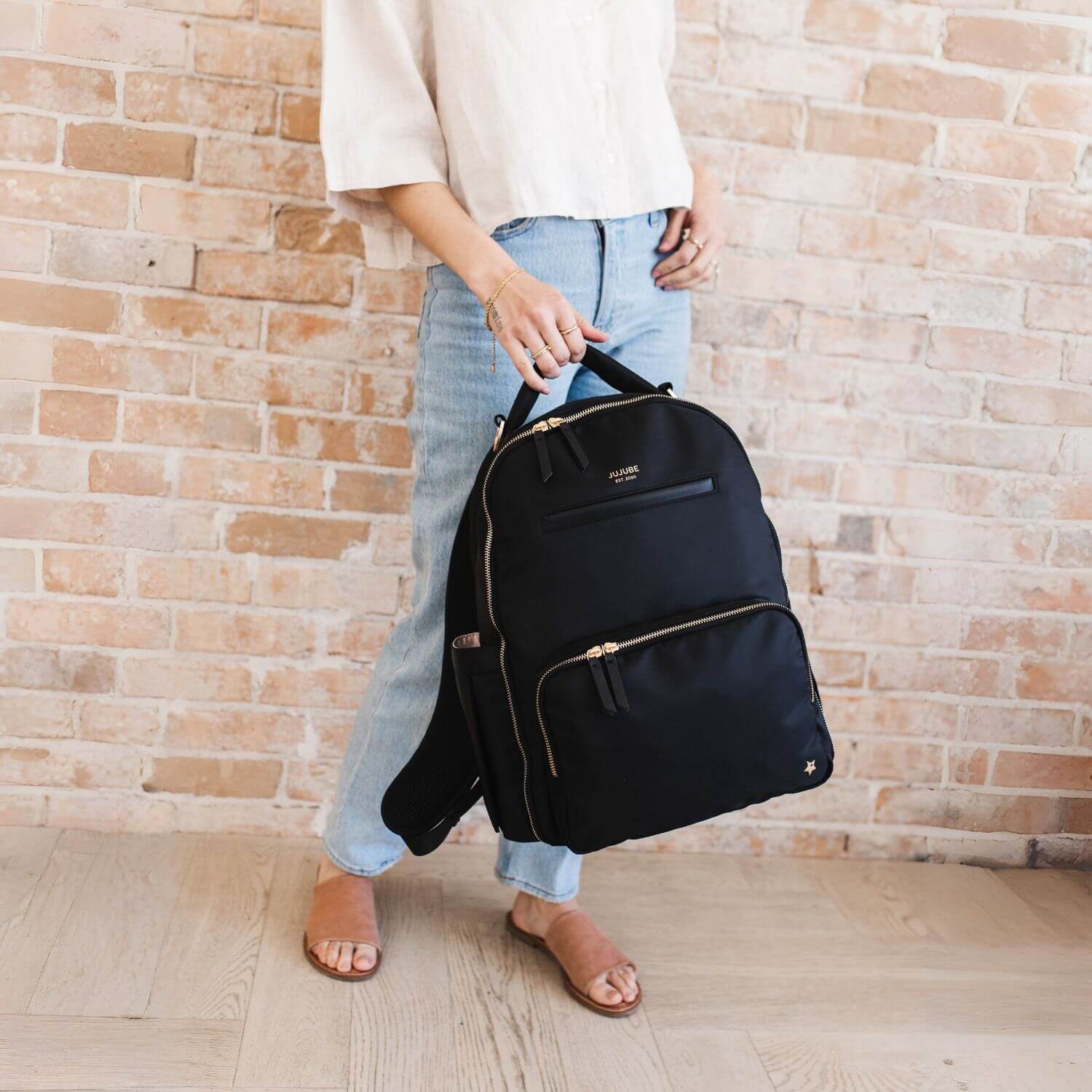 Girl Holding JuJuBe Classic Diaper Backpack Black