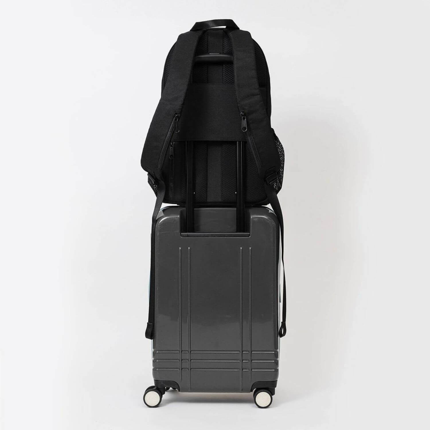 augustnoa Classic Noa Backpack Black attached to Luggage