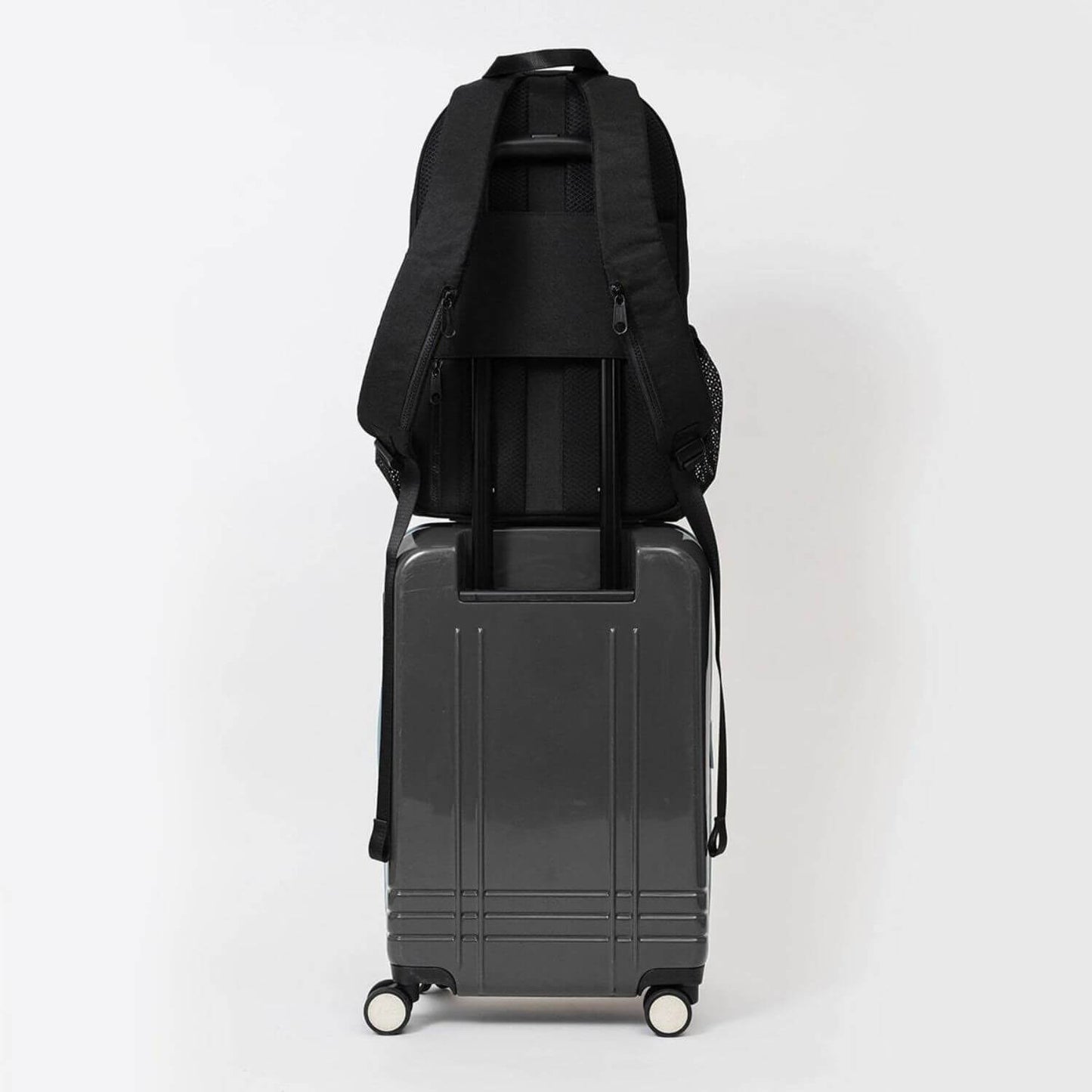 augustnoa Classic Noa Backpack Black attached to Luggage