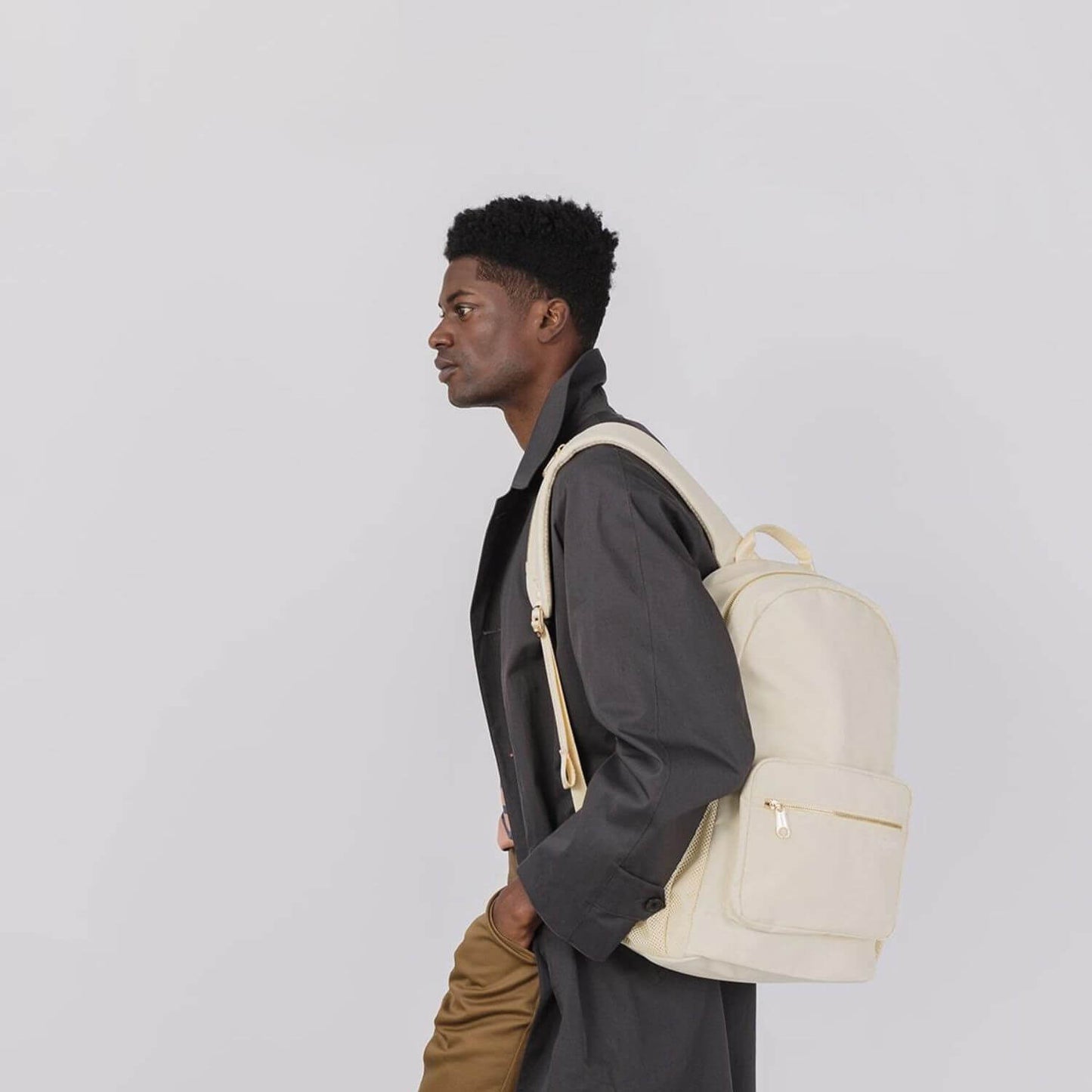 Man Carrying augustnoa Classic Noa Backpack Cream