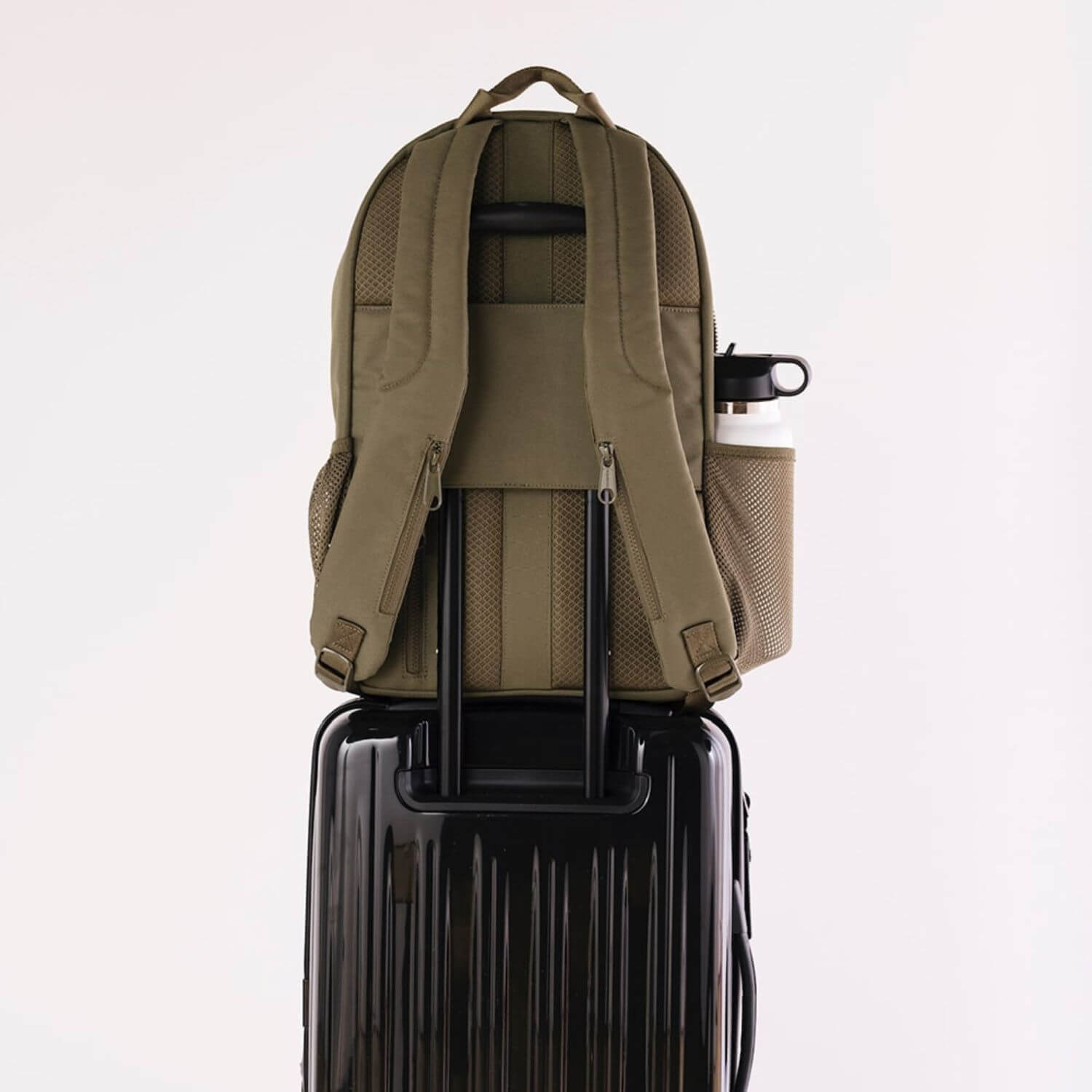 augustnoa Classic Noa Backpack Olive attached to Luggage