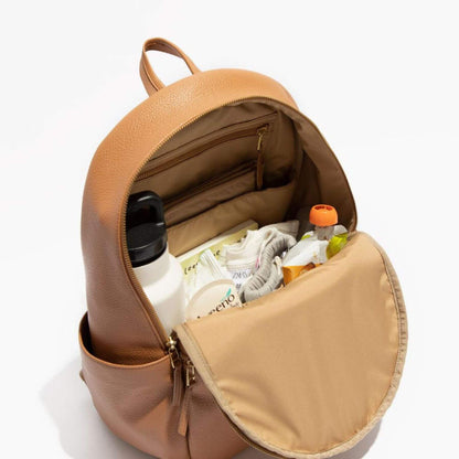 Open brown leather backpack with items inside on a white background