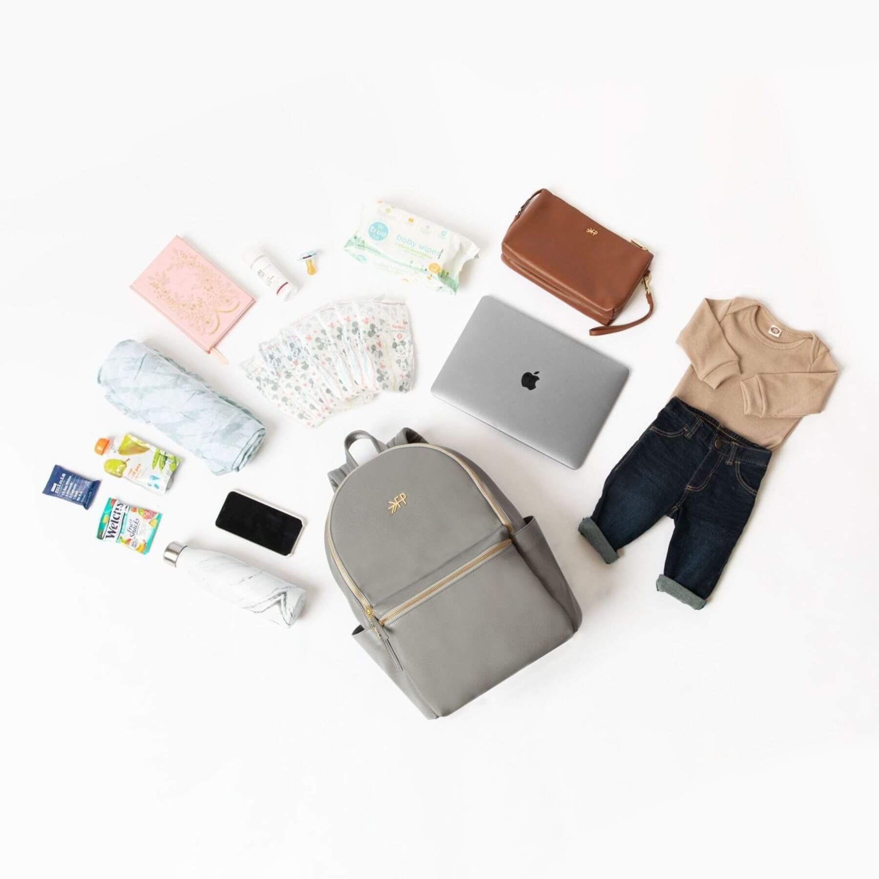 Collection of baby items including a backpack, clothes, and accessories on a white background