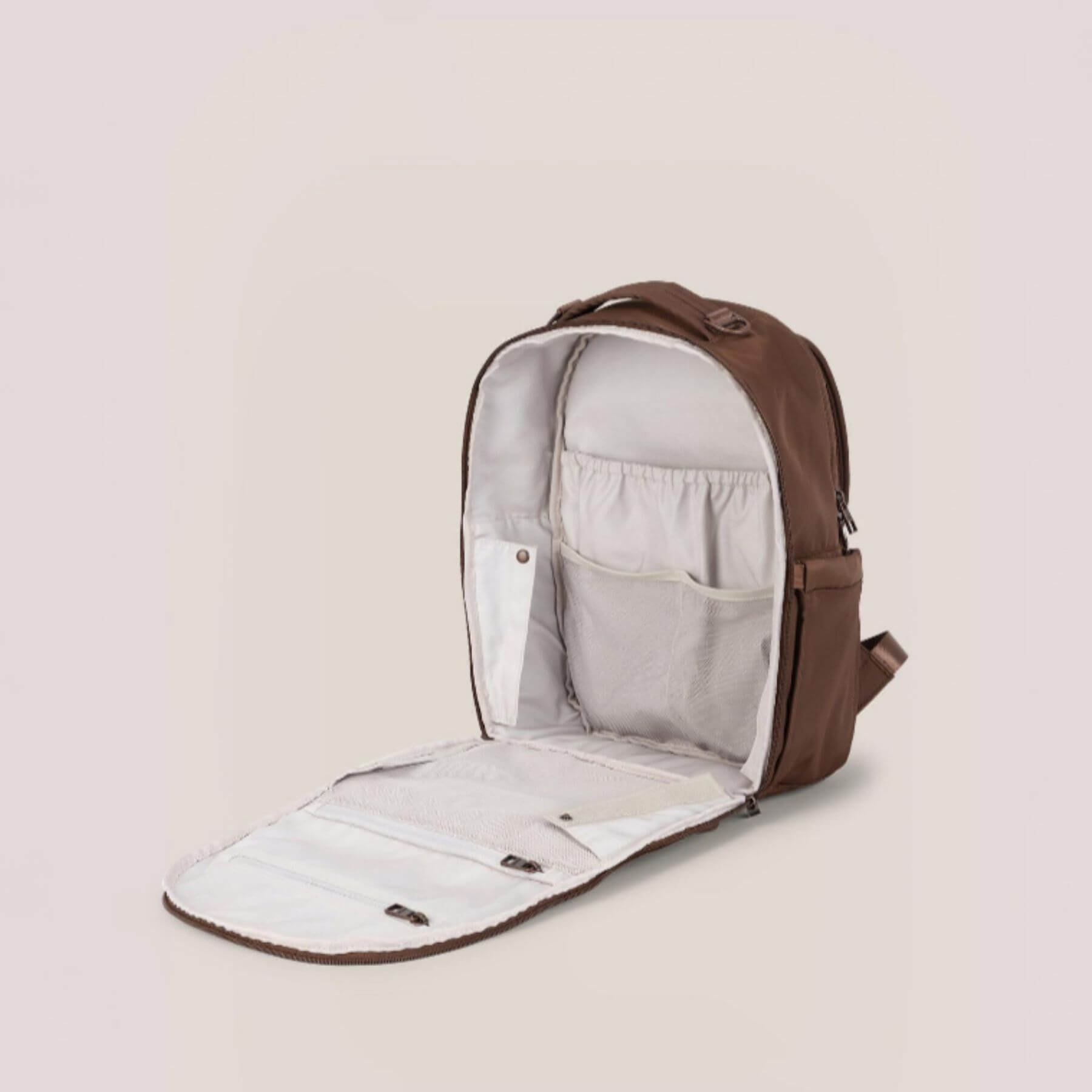 JuJuBe Classic Diaper Backpack Espresso with a clear interior on a beige background