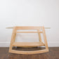 Plum+Sparrow Classic Rocking Moses Bassinet Stand with brake Natural on a wooden floor with a white wall background