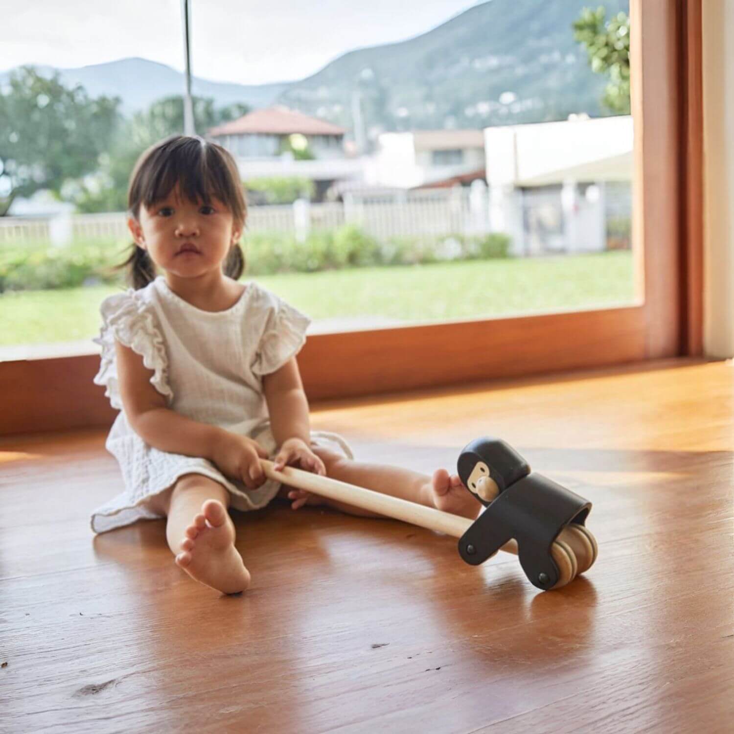 Girl Playing PlanToys Climbing Gorilla