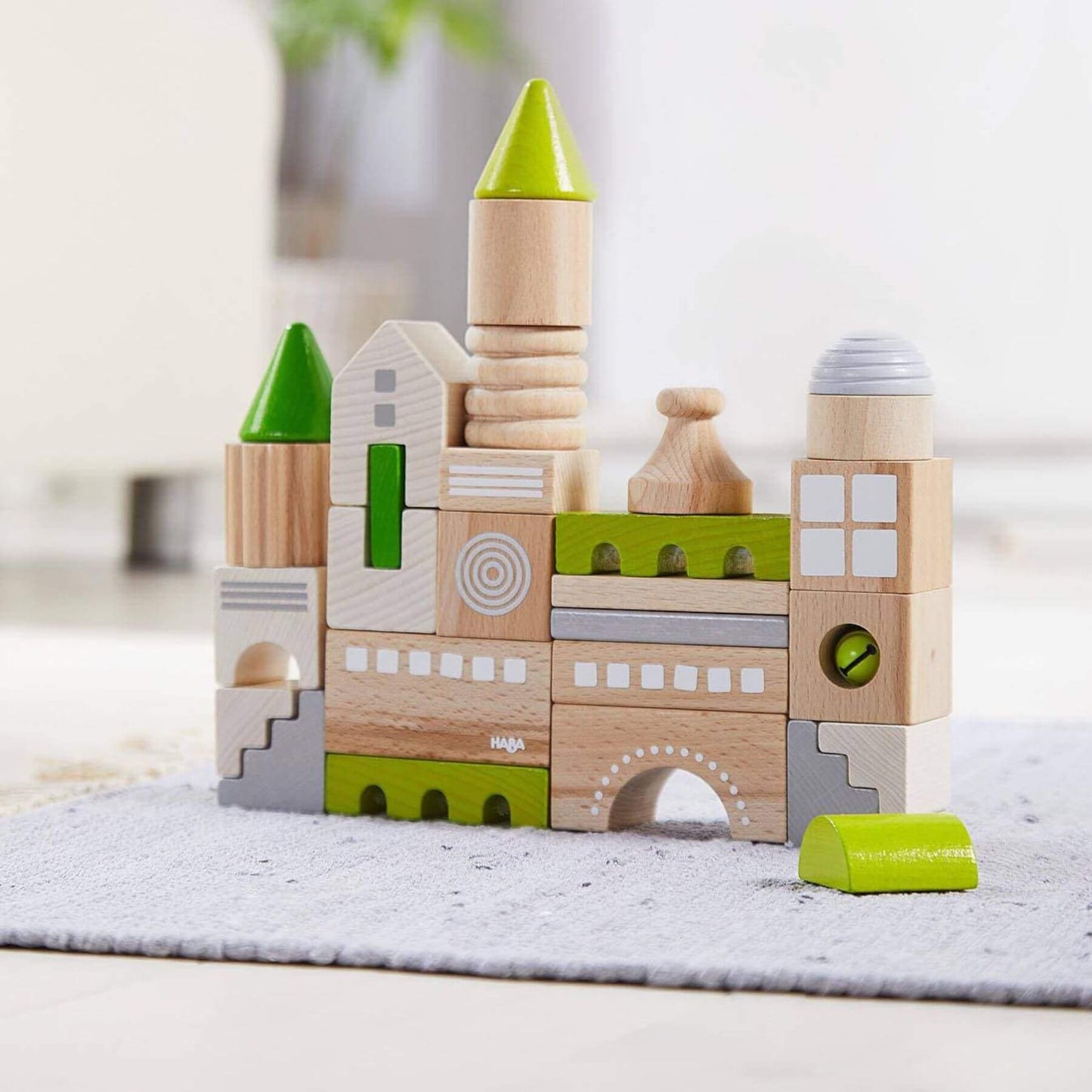 HABA USA Coburg 28 Piece Wooden Building Blocks on a light surface with a blurred background
