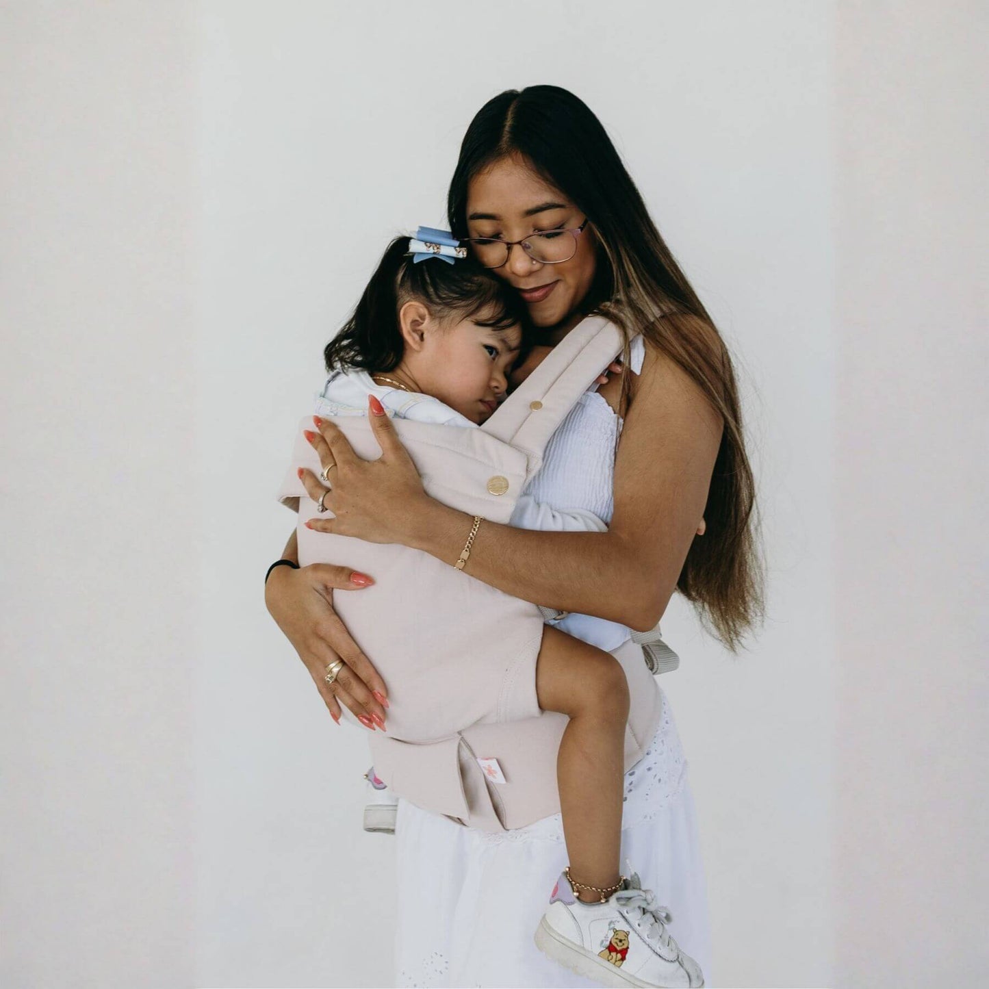Woman holding a child in Coco Cream - Cotton Linen Baby Carrier