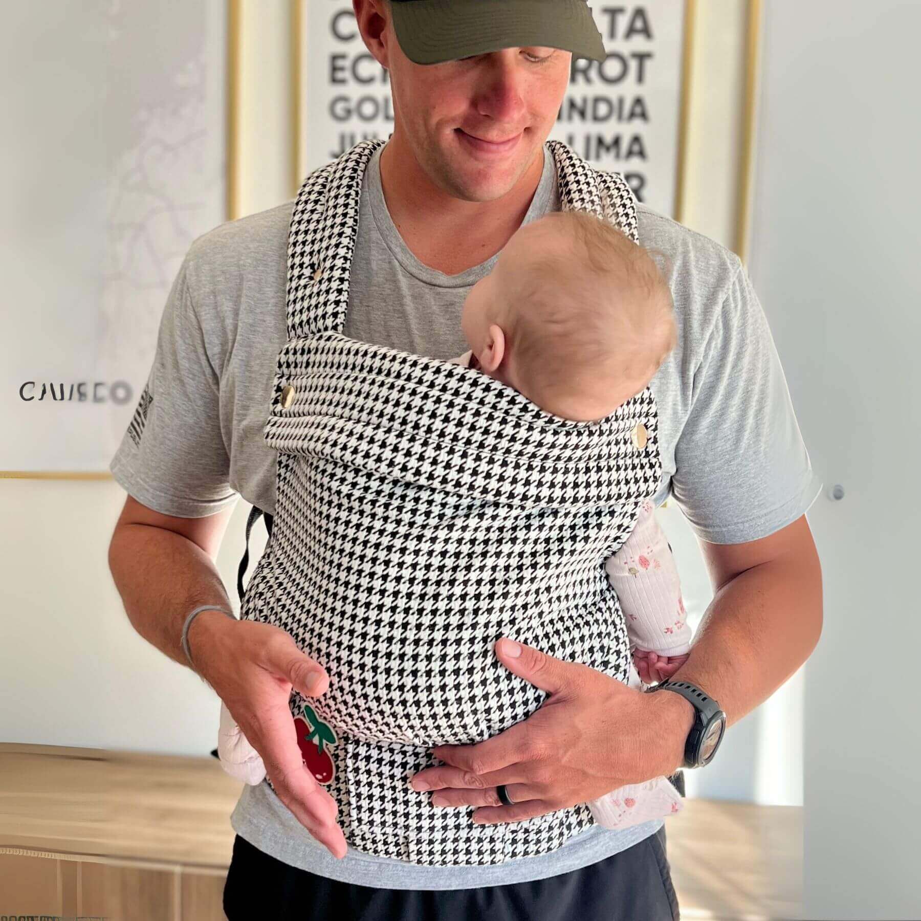 Man holding a baby in Coco Houndstooth - Woven Jacquard indoors.