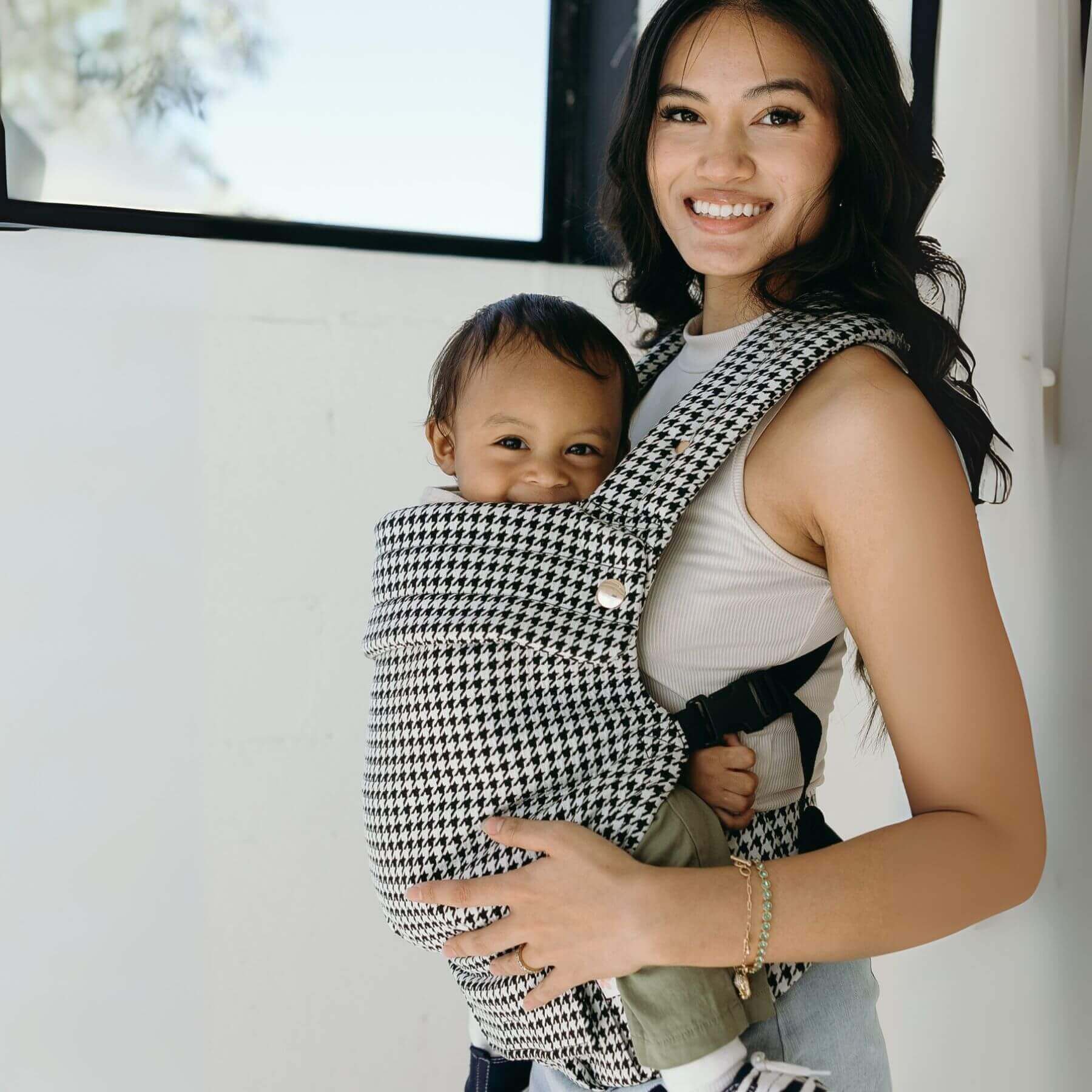 Woman holding a baby in Coco Houndstooth - Woven Jacquard indoors.