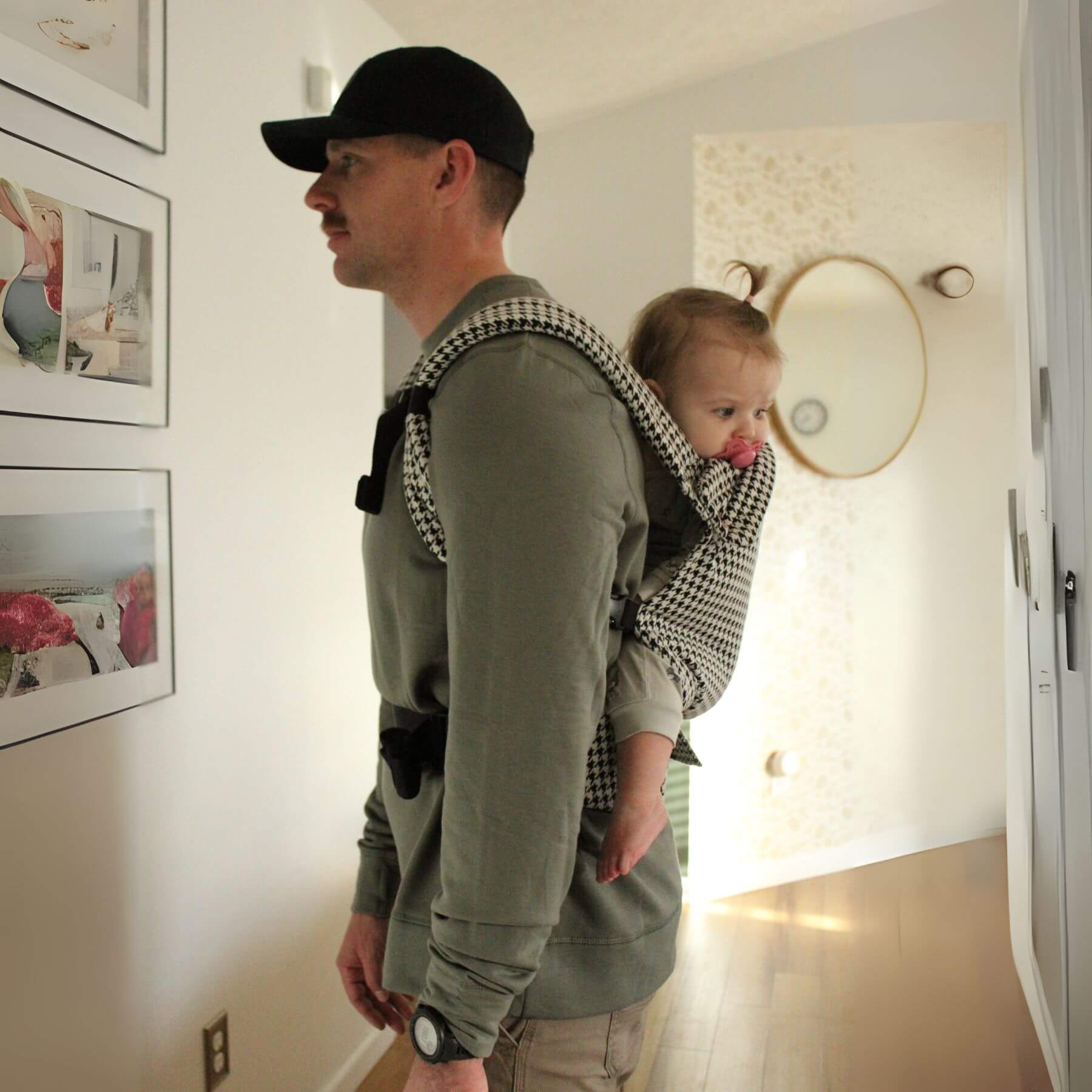 Man carrying a child in Coco Houndstooth - Woven Jacquard inside a home.