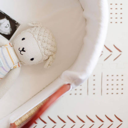 Close-up of Plum+Sparrow Cognac Handle Moses Basket