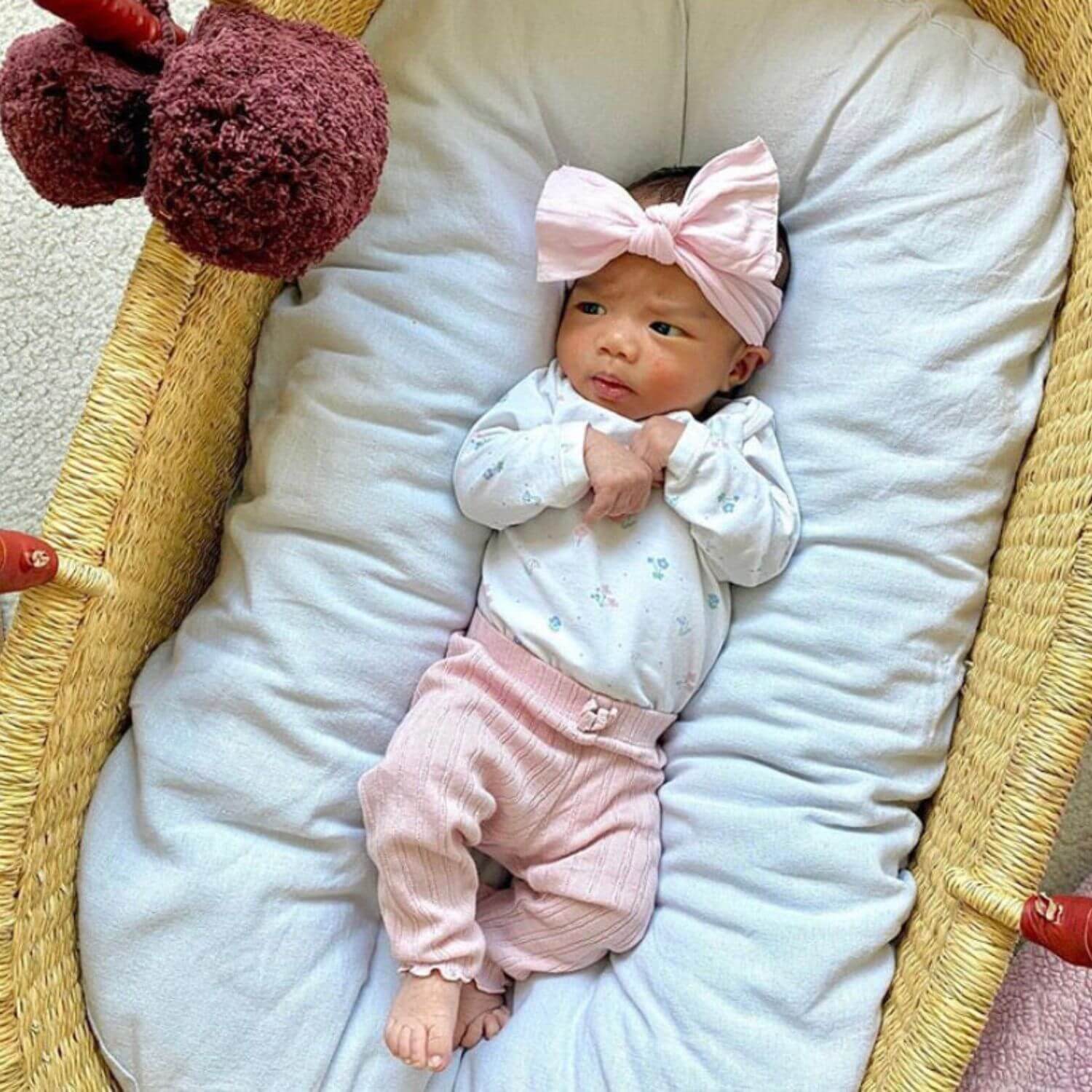 Baby sleeping in Plum+Sparrow Cognac Handle Moses Basket