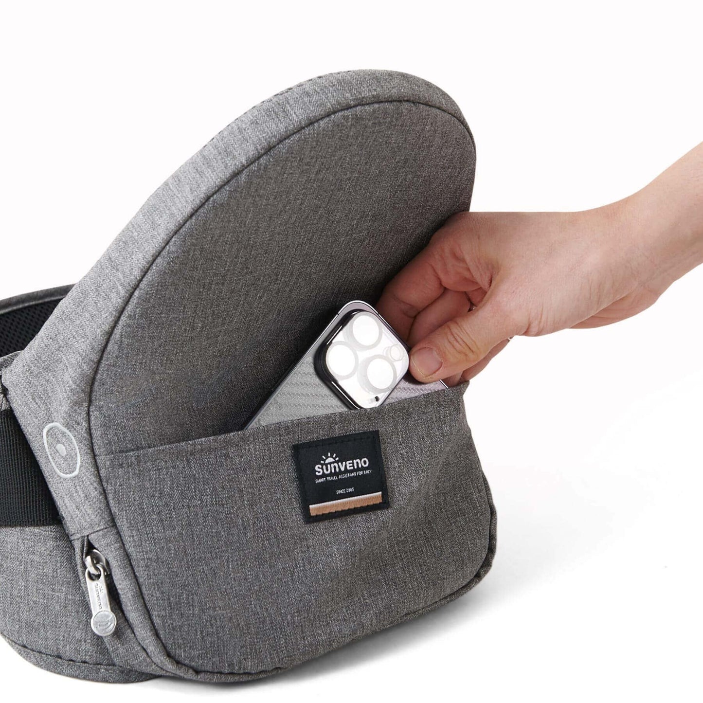 Hand putting a phone into Sunveno Collapsible Hipseat Carrier