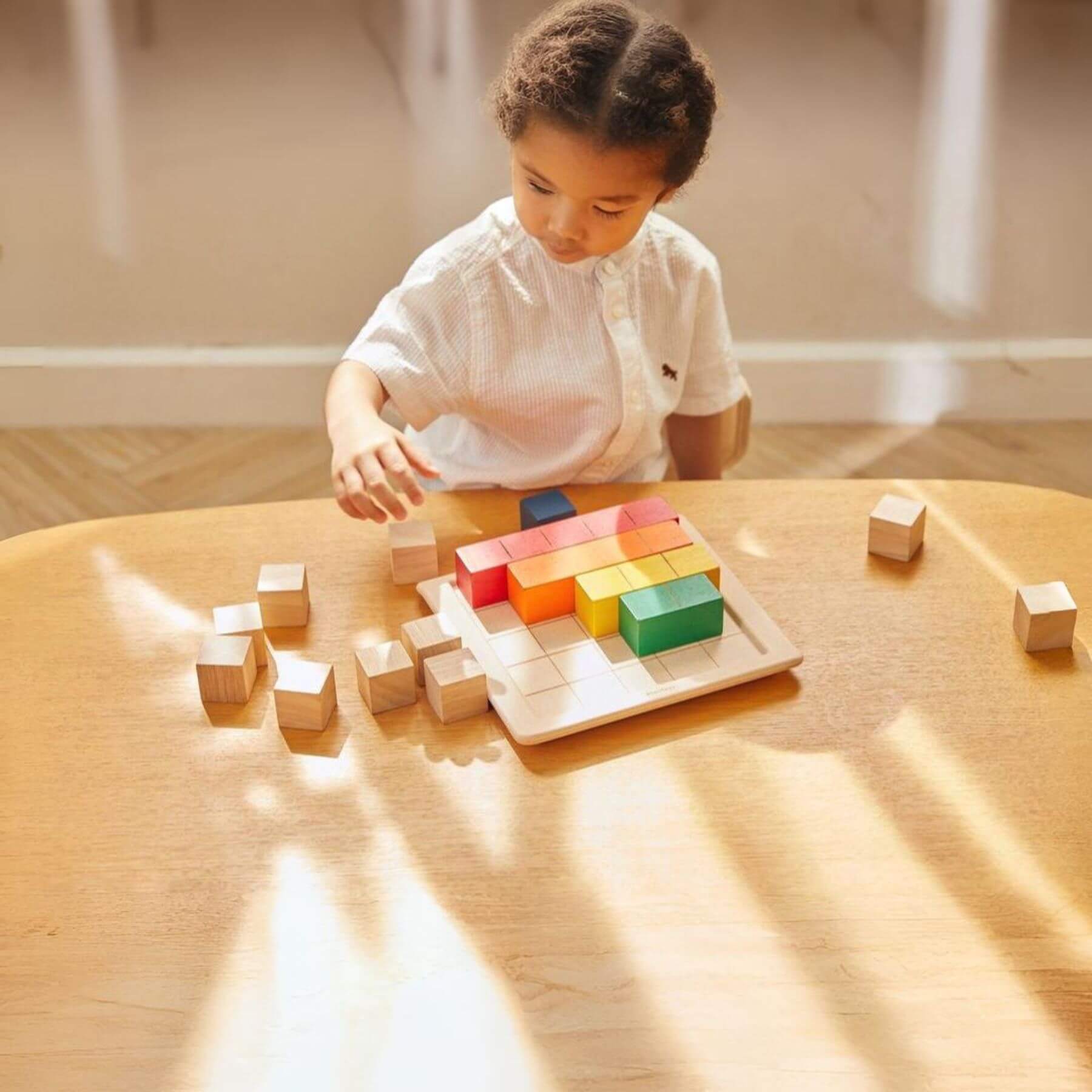 Girl Playing PlanToys Colored Counting Blocks - Unit Plus