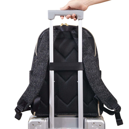 Sunveno Convertible Tweed Diaper Backpack Black attached to a suitcase