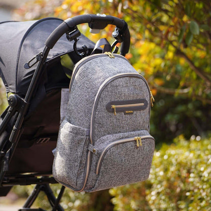 Sunveno Convertible Tweed Diaper Backpack Gray attached to a stroller with a blurred natural background