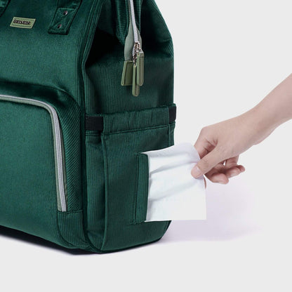 Corduroy Diaper Backpack Green with a hand pulling out a white paper from a pocket