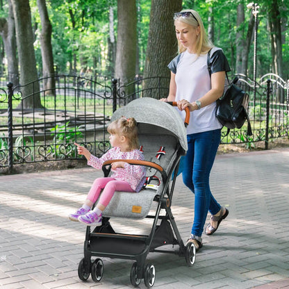 Woman pushing a stroller with a child in a park
