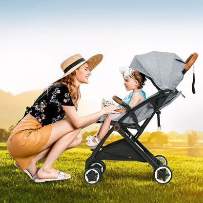 Woman with a child in a stroller in a grassy field