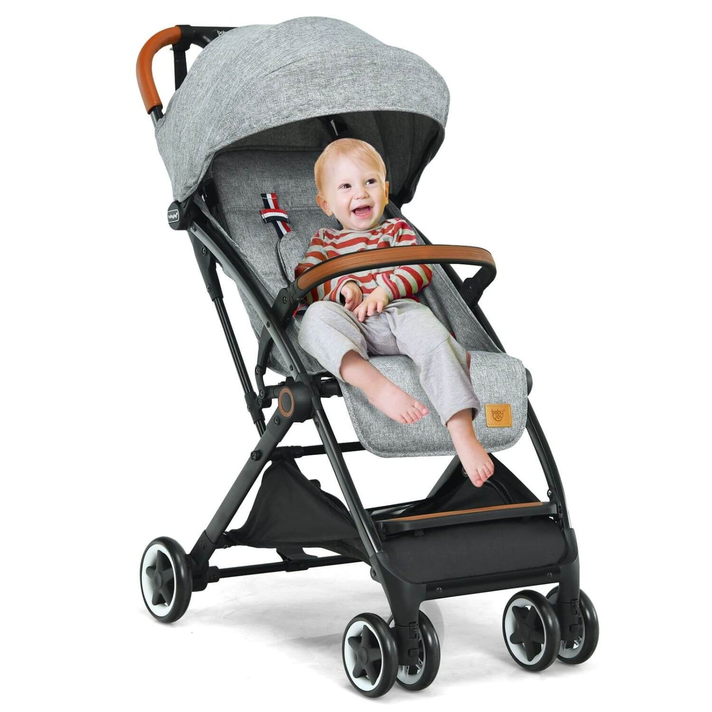 Child sitting in a gray stroller on a white background