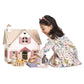Child playing with Tender Leaf Cottontail Cottage and accessories on a white background