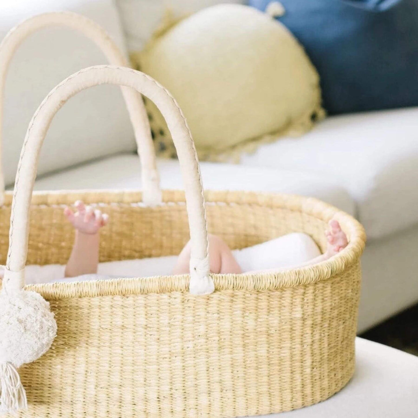 Baby sleeping in Plum+Sparrow Cream Handle No Hood Moses Basket
