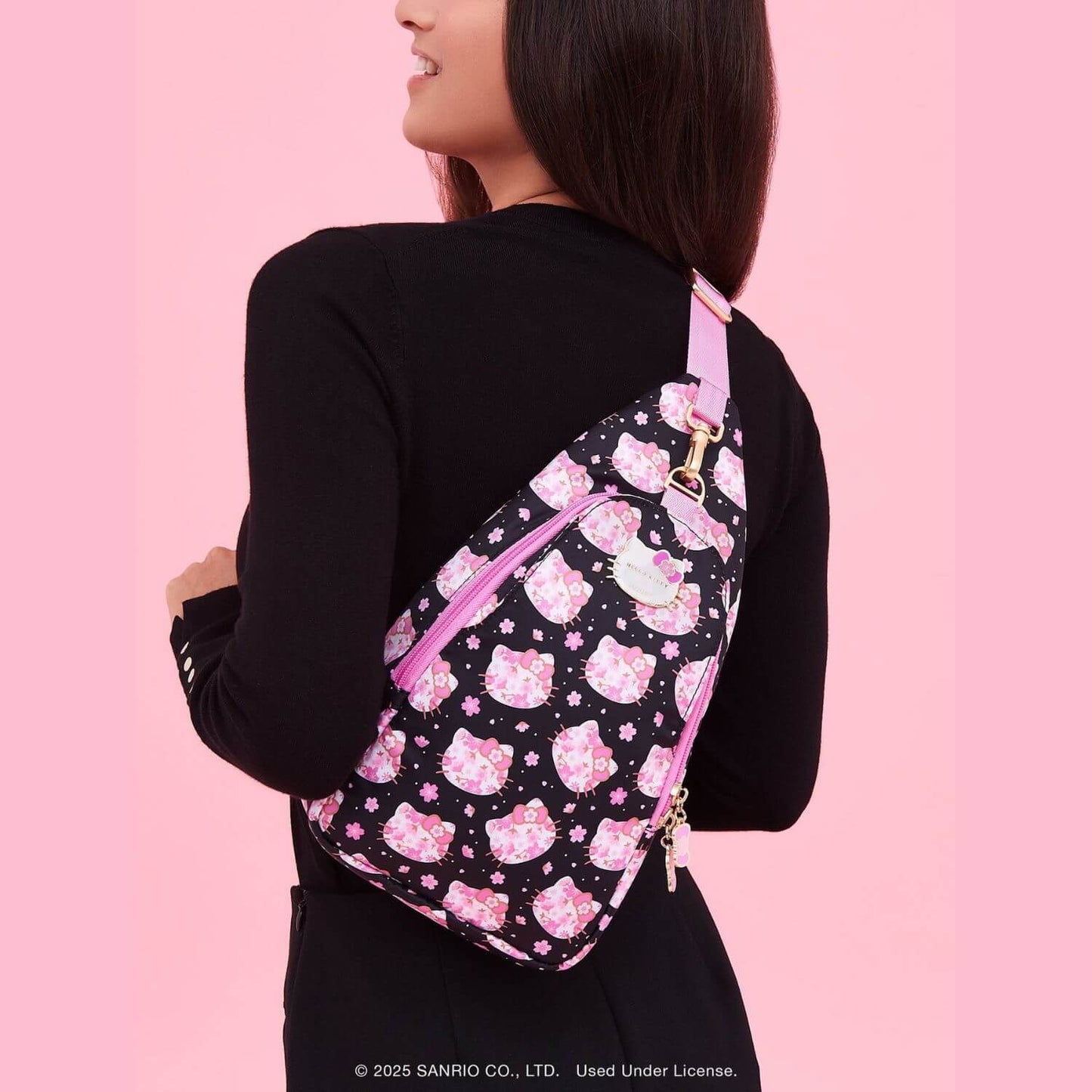 Person wearing Crossbody Sling Cherry Blossoms on a pink background