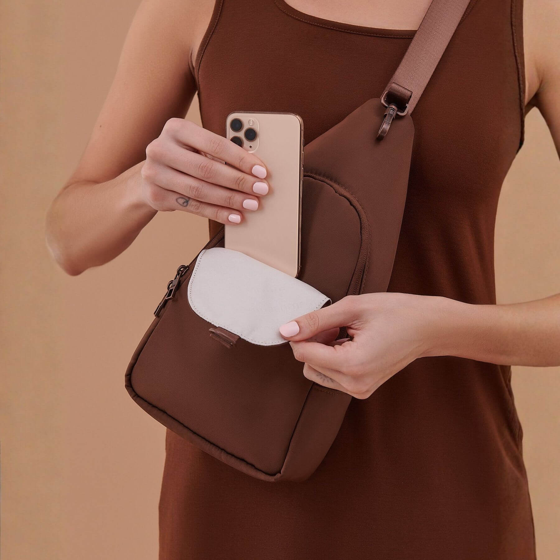 Woman carrying JuJuBe Crossbody Sling - Espresso