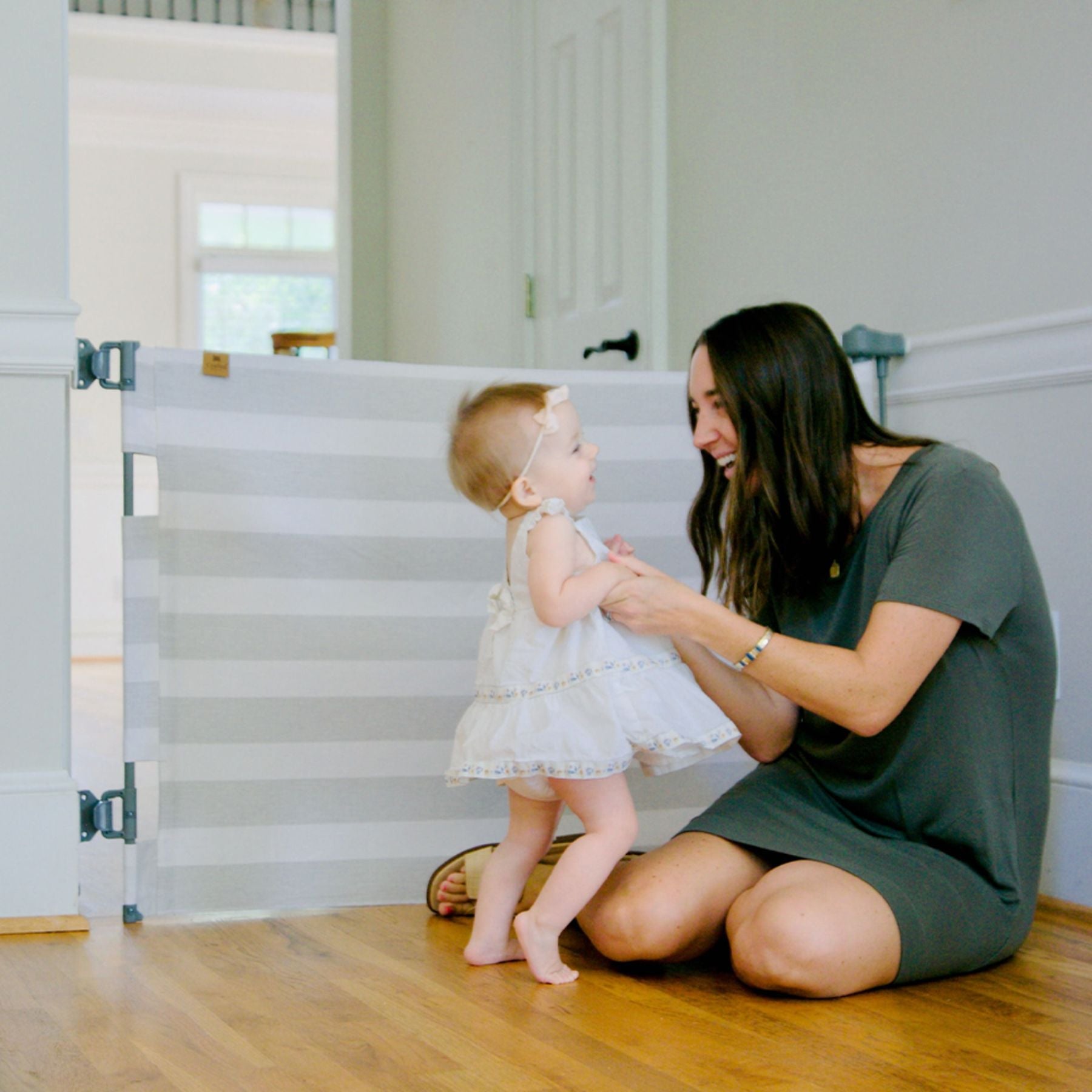 Woman sitting on the floor with a young child near Crypton® Fabric Baby & Pet Safety Gate - Cloud Grey