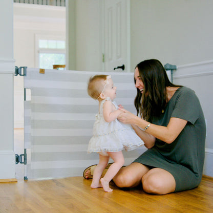 Woman sitting on the floor with a young child near Crypton® Fabric Baby & Pet Safety Gate - Cloud Grey