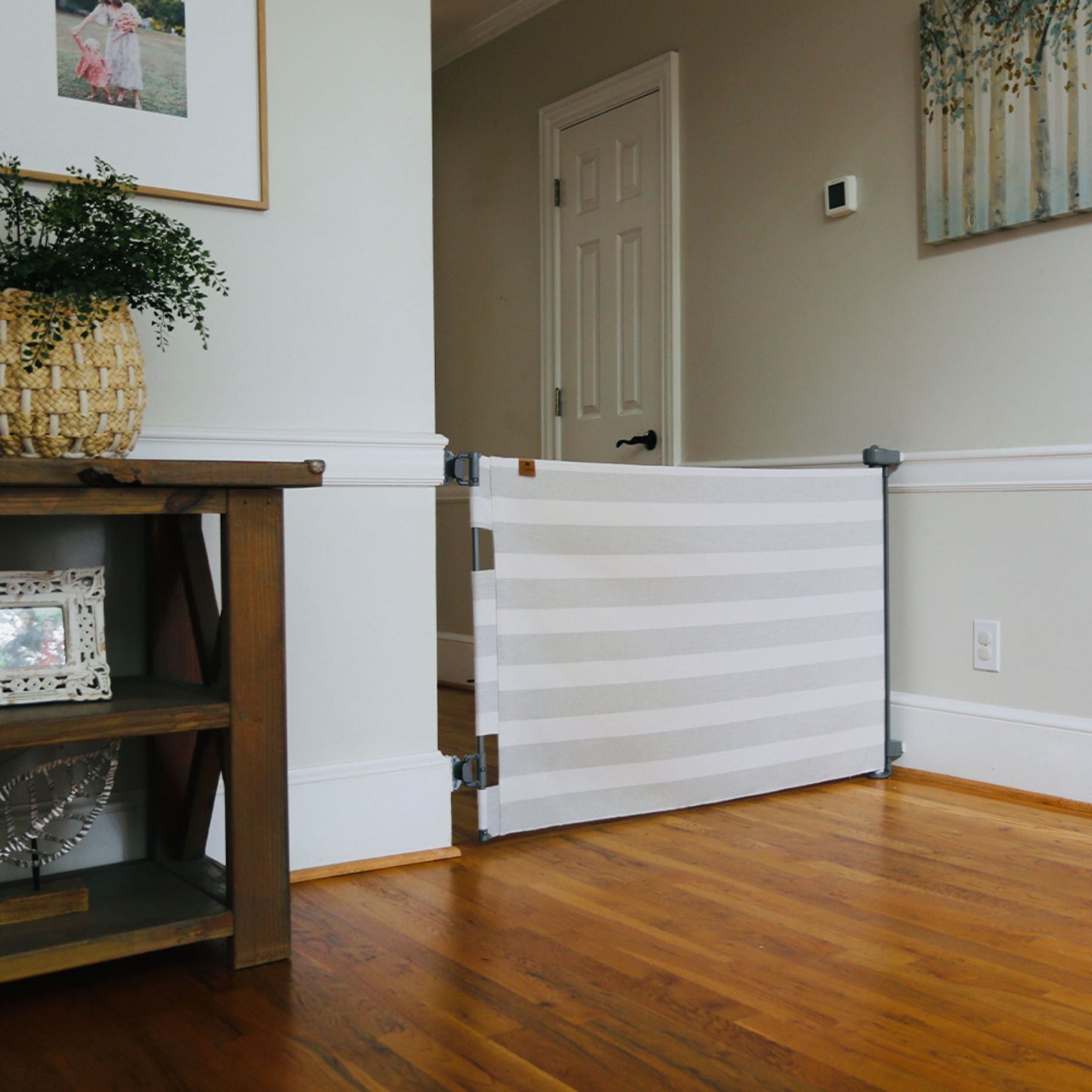 Crypton® Fabric Baby & Pet Safety Gate - Cloud Grey in a room with wooden floor and furniture