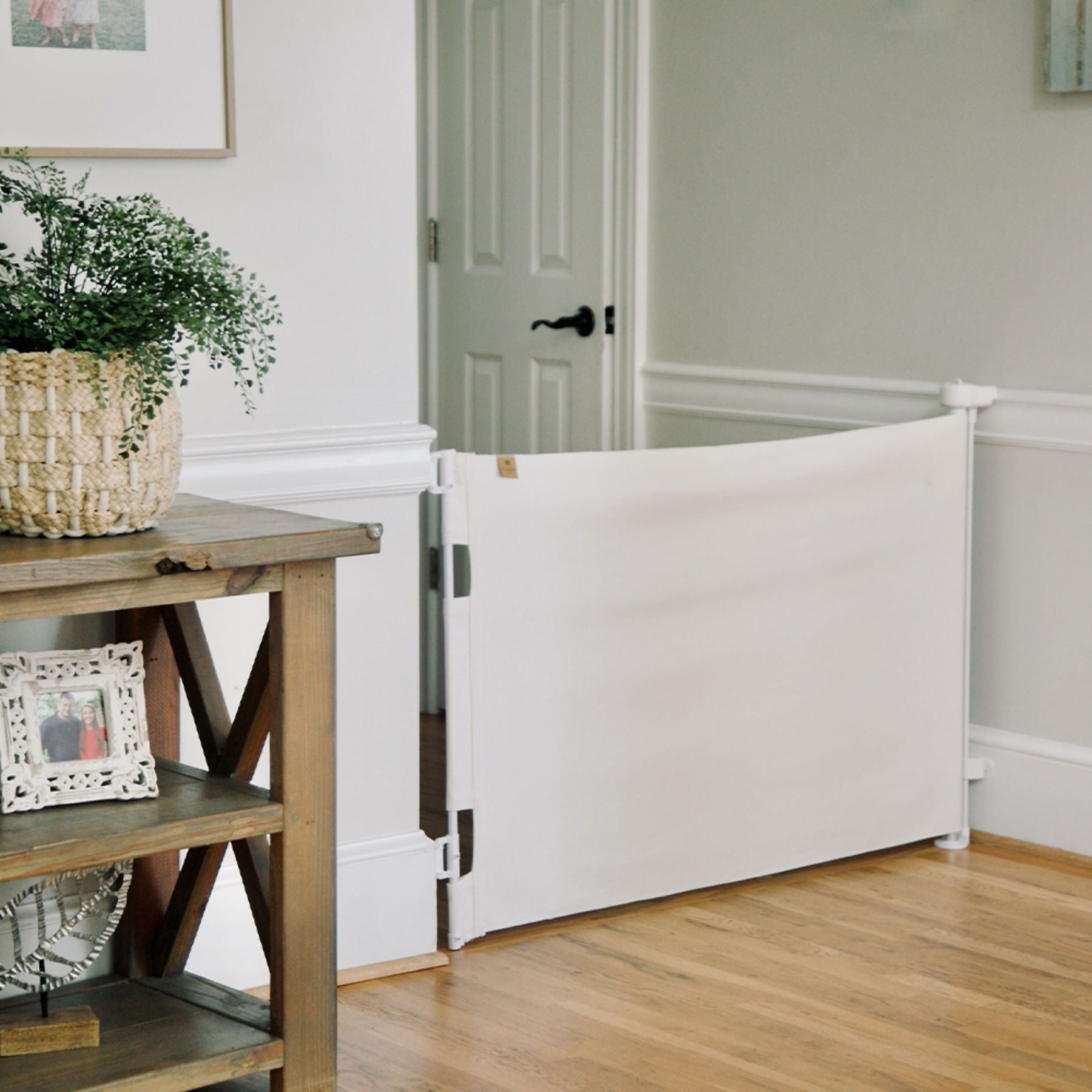 Crypton® Fabric Baby & Pet Safety Gate - eggshell in a room with wooden floor and furniture.