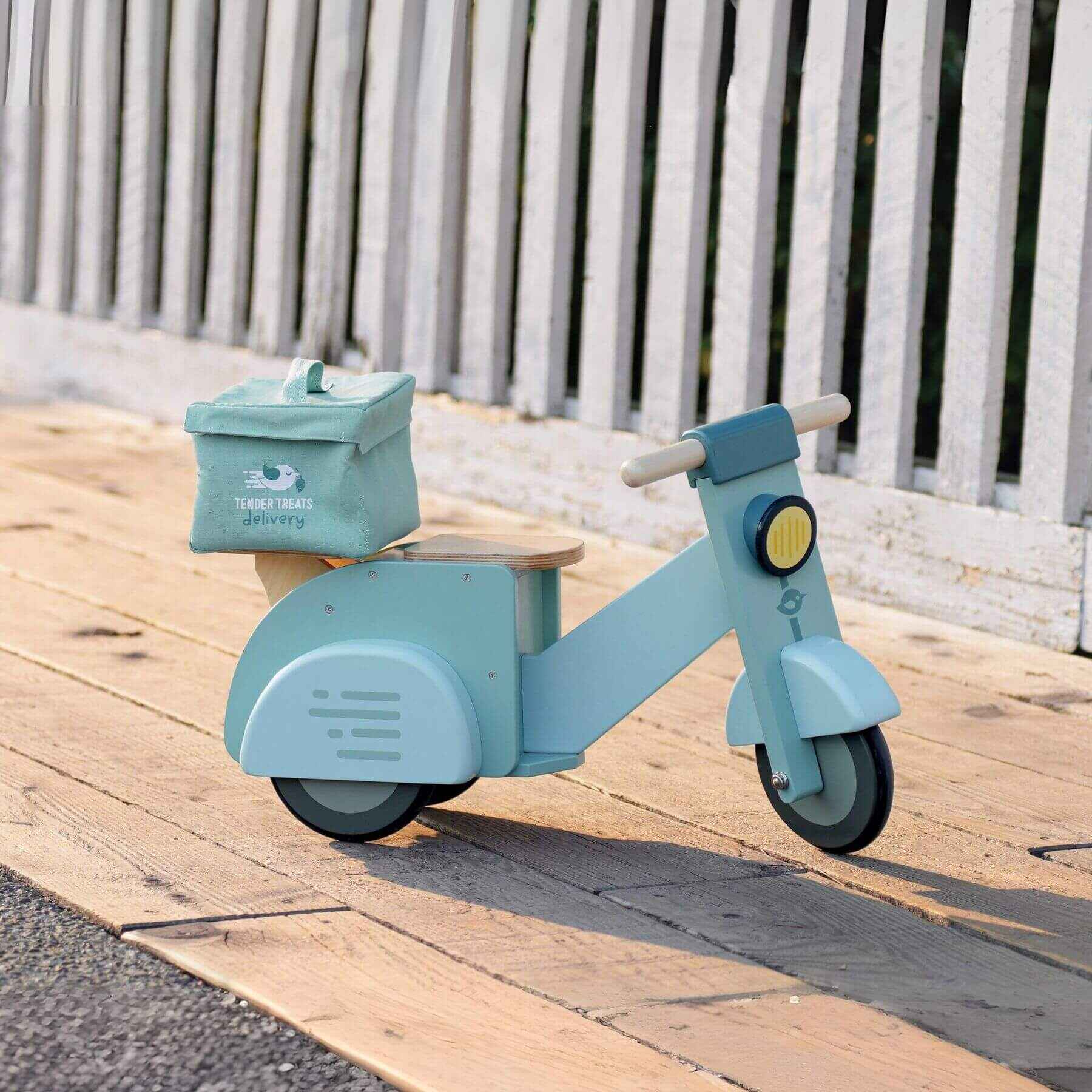 Tender Leaf Delivery Scooter on a wooden surface.