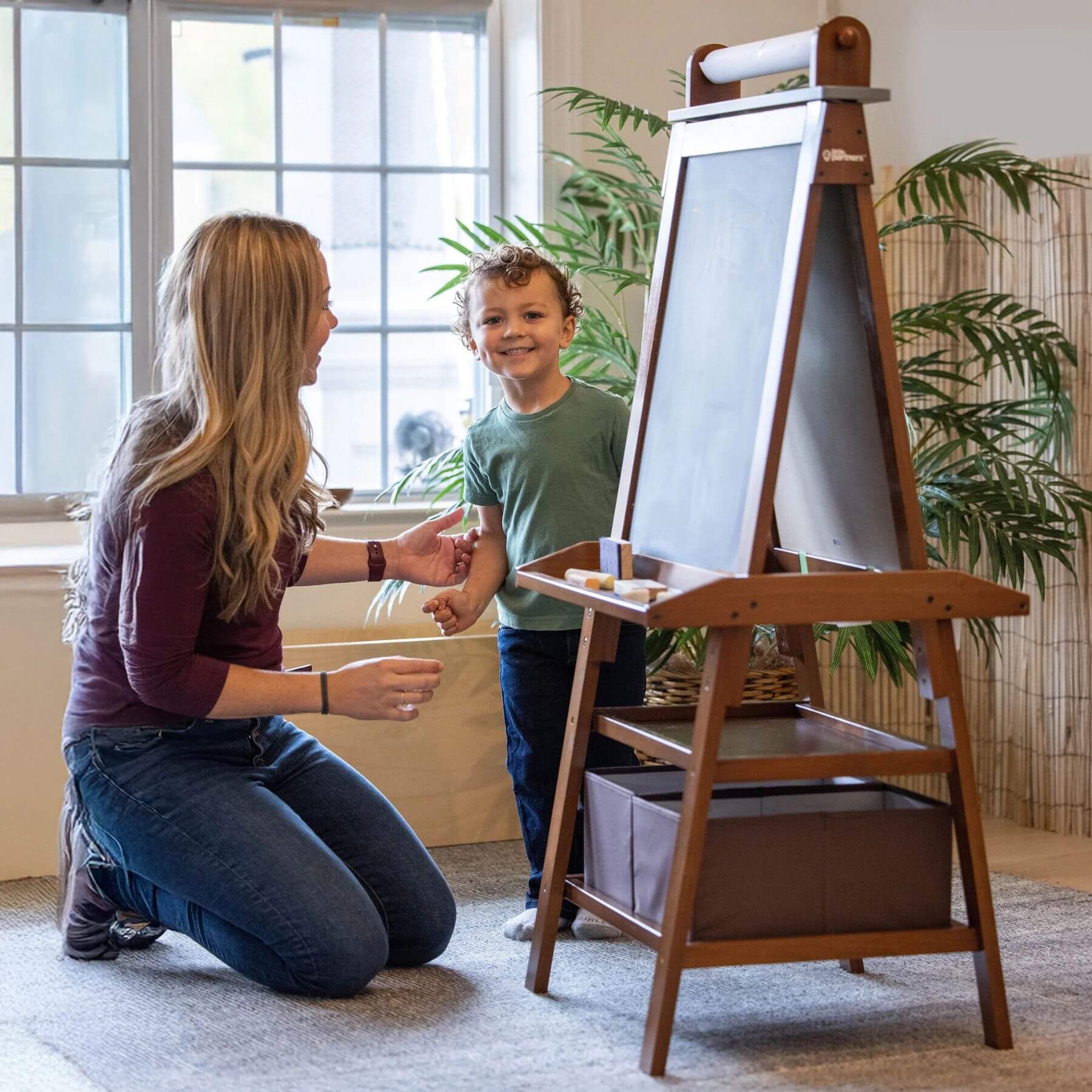 Mom & Boy next to Little Partners Deluxe Learn & Play Art Center Espresso