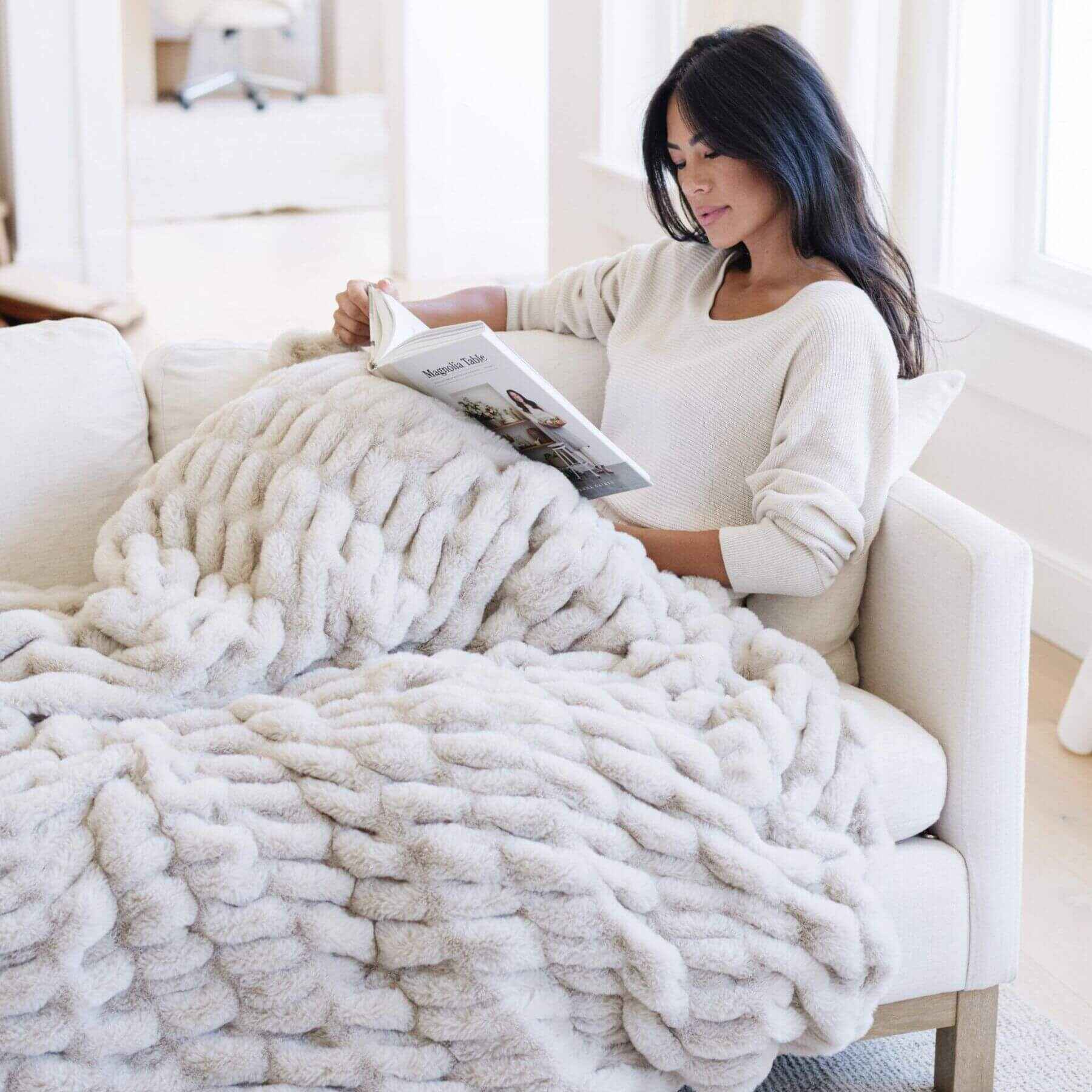 Woman Reading under Saranoni Double Ruched Faux Fur Throw Blankets Flax