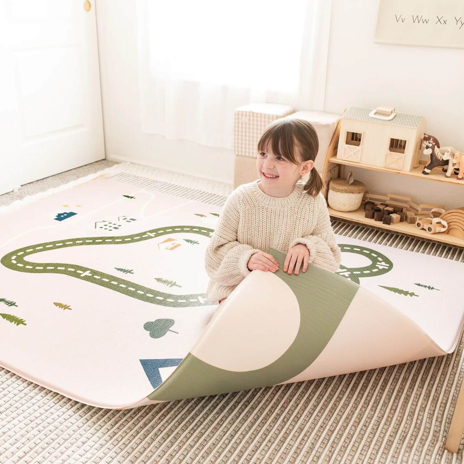 Girl Lifting Tiny Land® Double-Sided Baby Playmat Forest Track Wonder