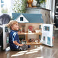 Child playing with Tender Leaf Dovetail House in a home setting