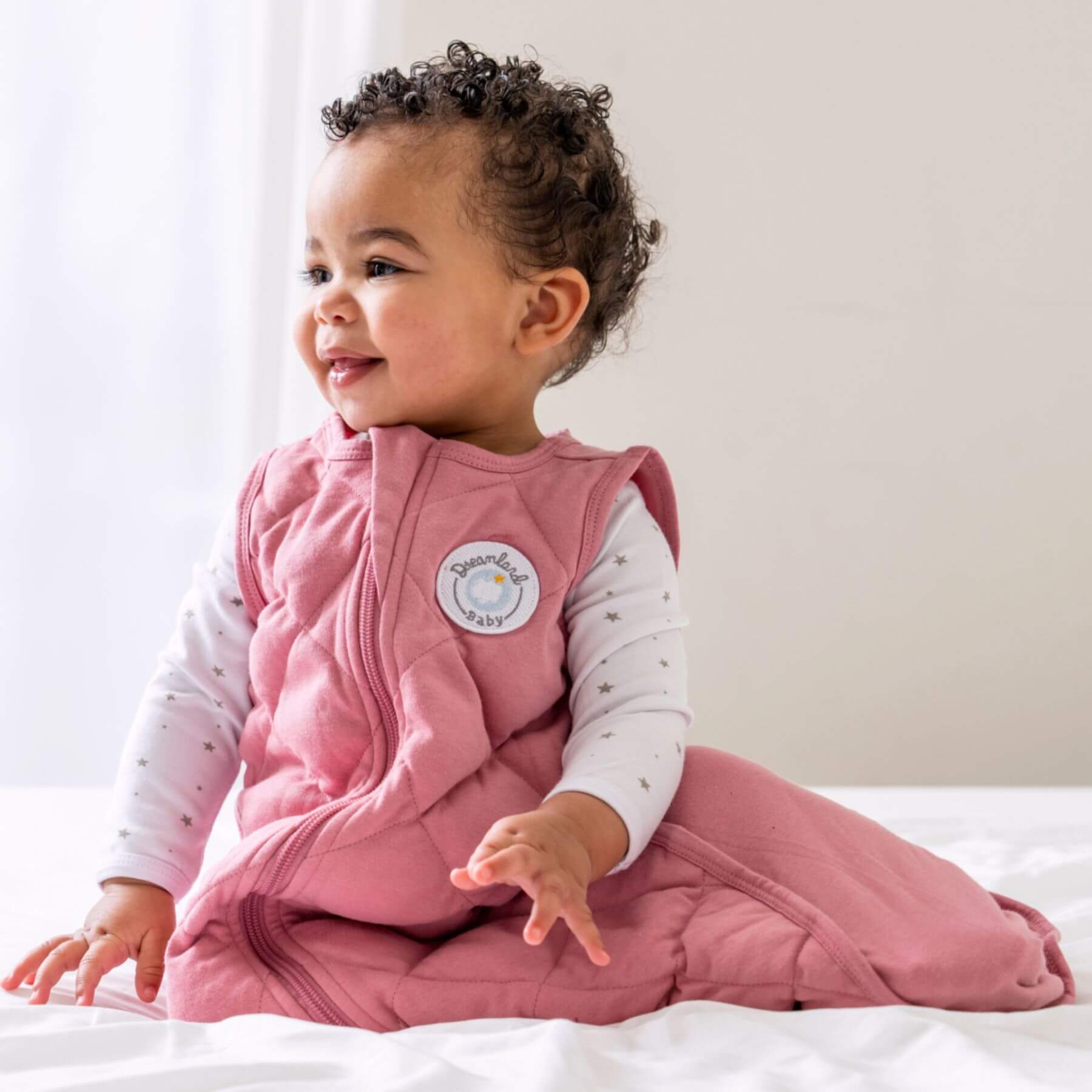 Baby wearing Dreamland Baby Dream Weighted Sleep Sack Dusty Rose