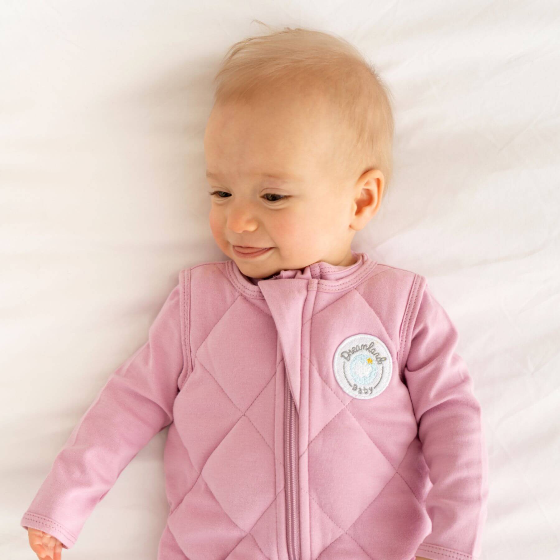 Baby wearing Dreamland Baby Dream Weighted Sleep Sack Misty Mauve