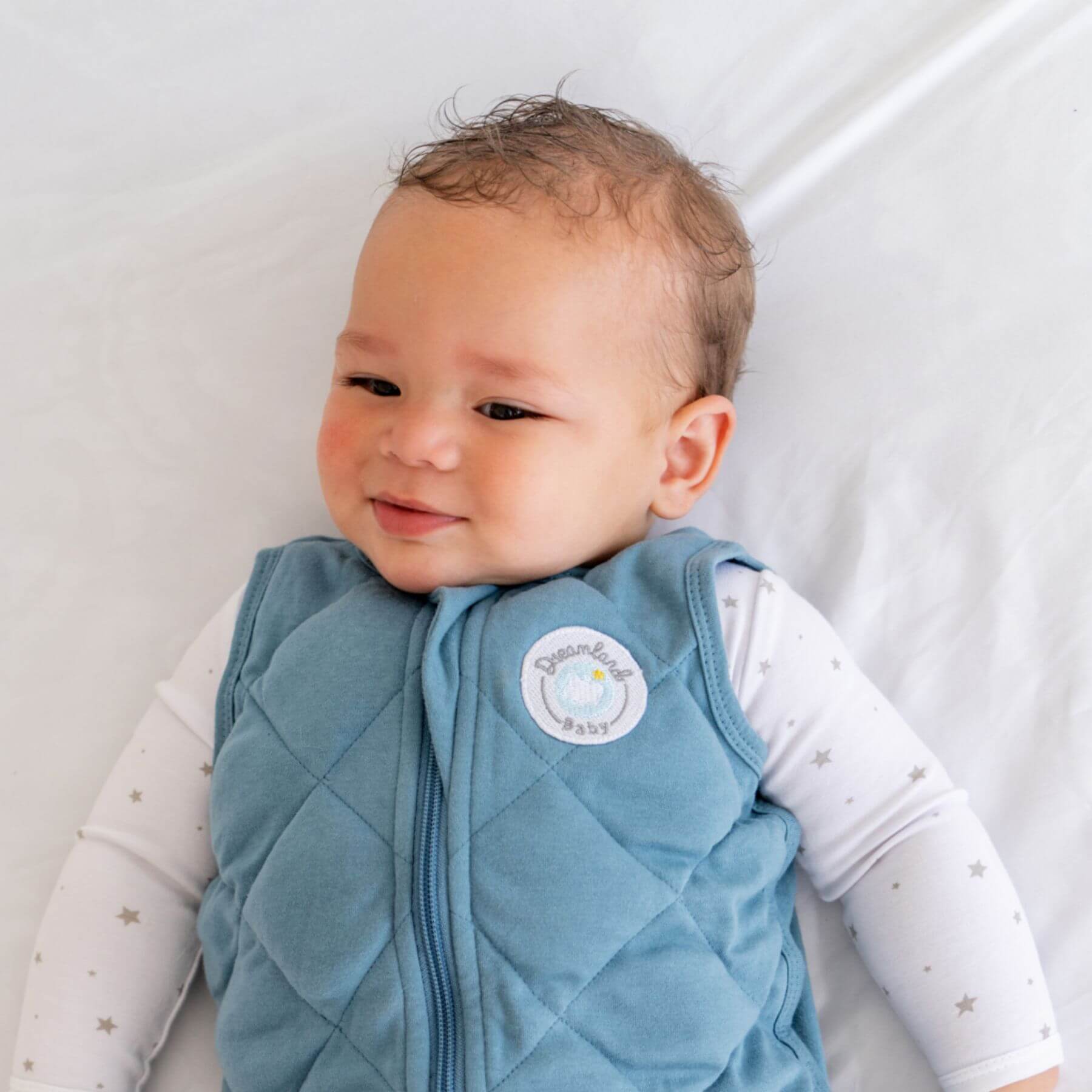Baby wearing Dreamland Baby Dream Weighted Sleep Sack Ocean Blue