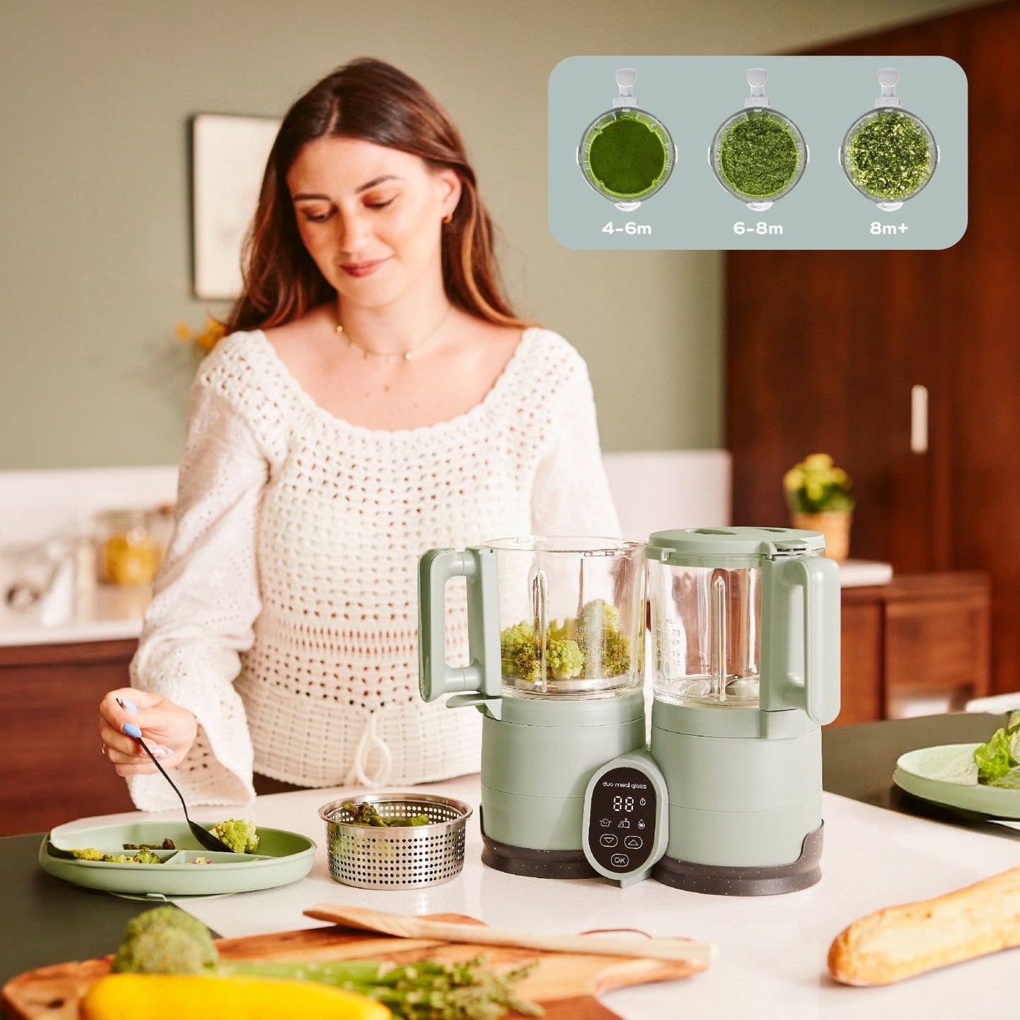 Woman in a kitchen preparing food with Babymoov Duo Meal Glass Pro Baby Food Maker