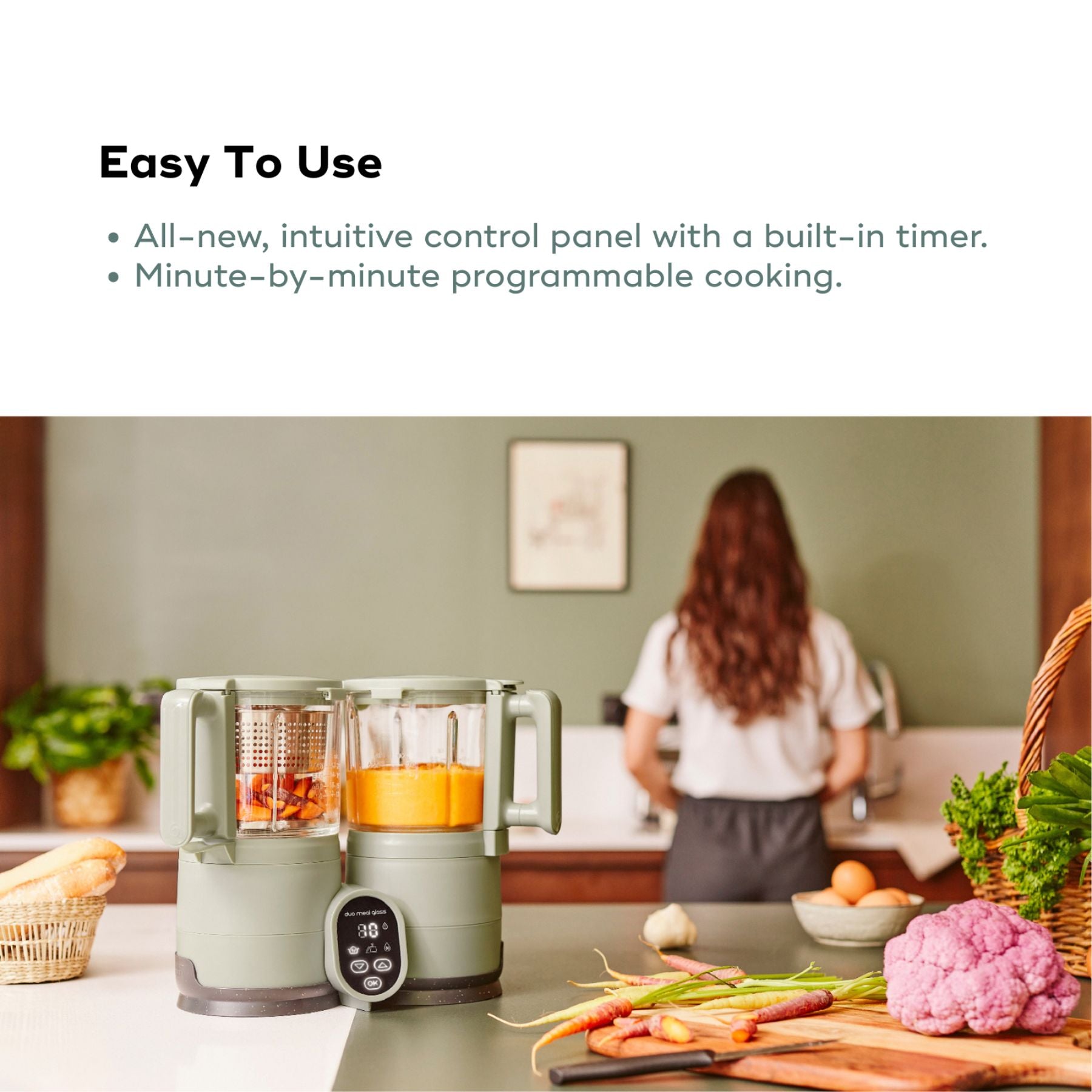 Kitchen scene with Babymoov Duo Meal Glass Pro Baby Food Maker and vegetables, featuring text about its ease of use.