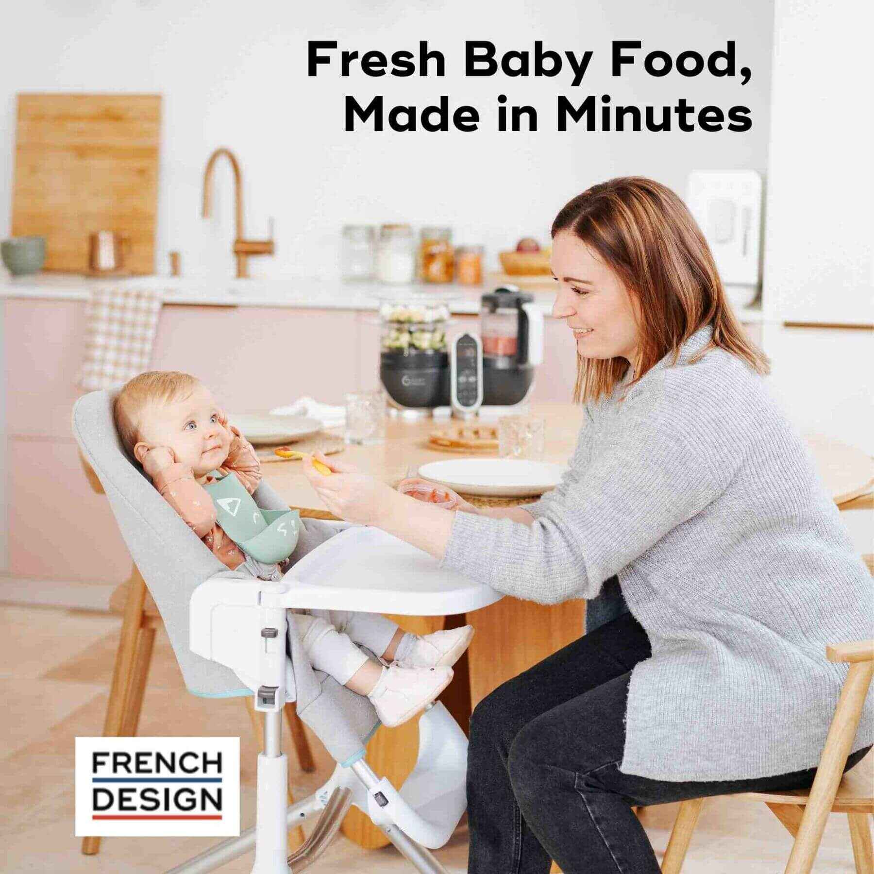 Woman feeding a baby in a high chair with kitchen background