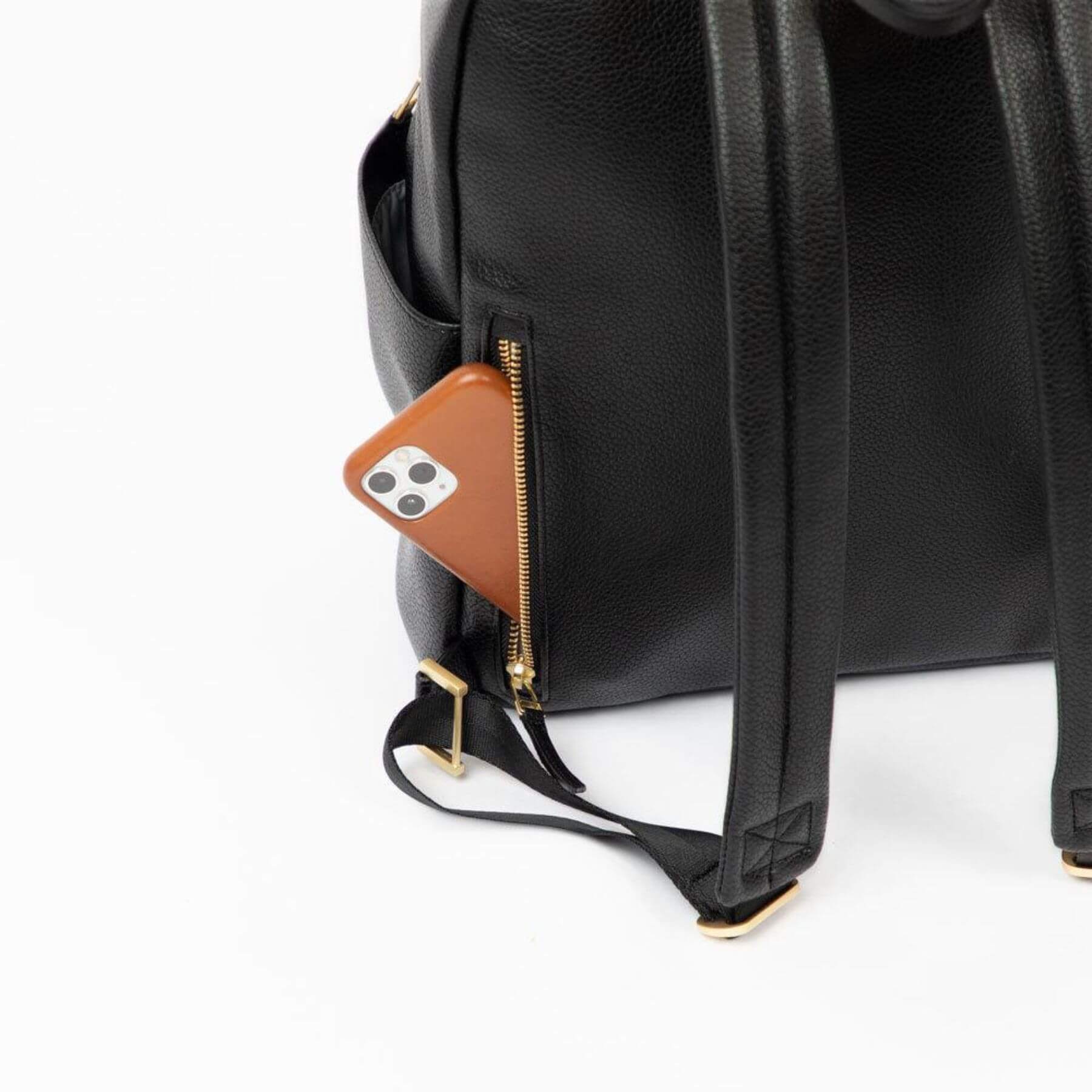 Black backpack with a brown phone case attached to a zipper pocket on a white background