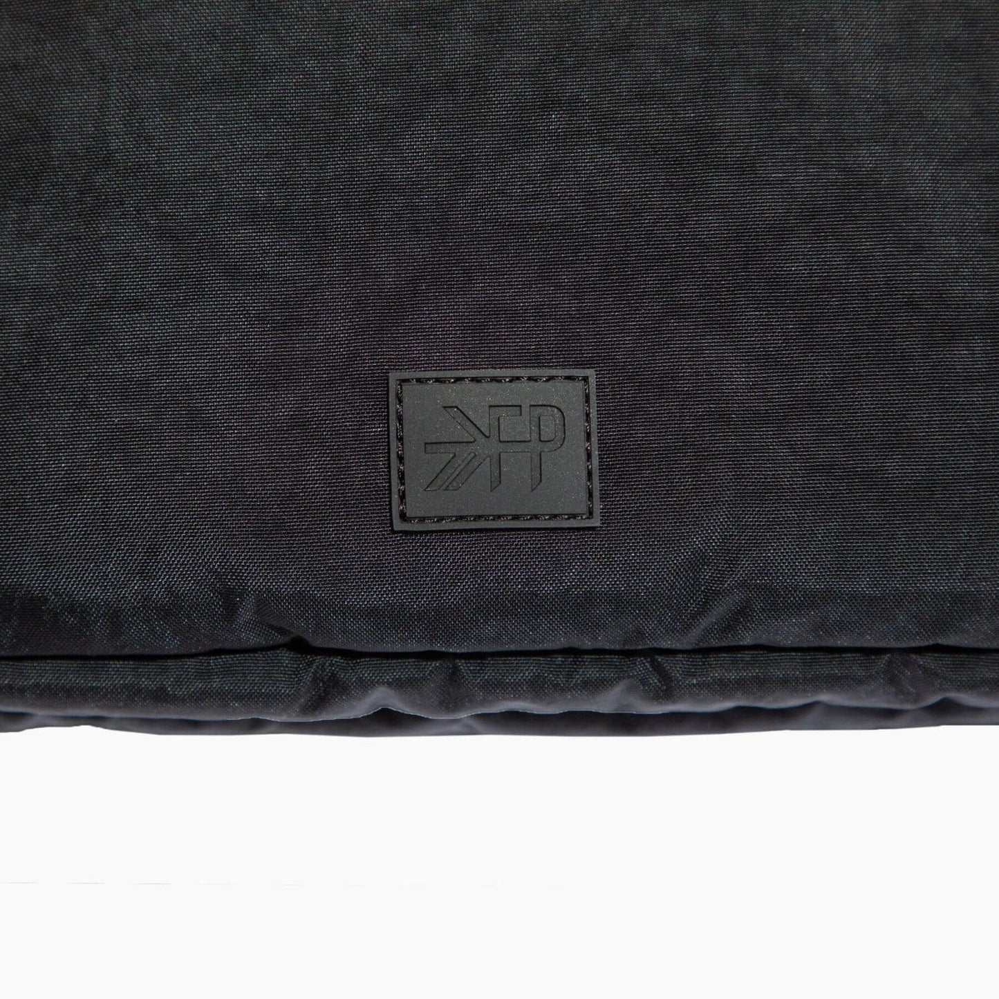Black textured fabric with a brand logo on a white background