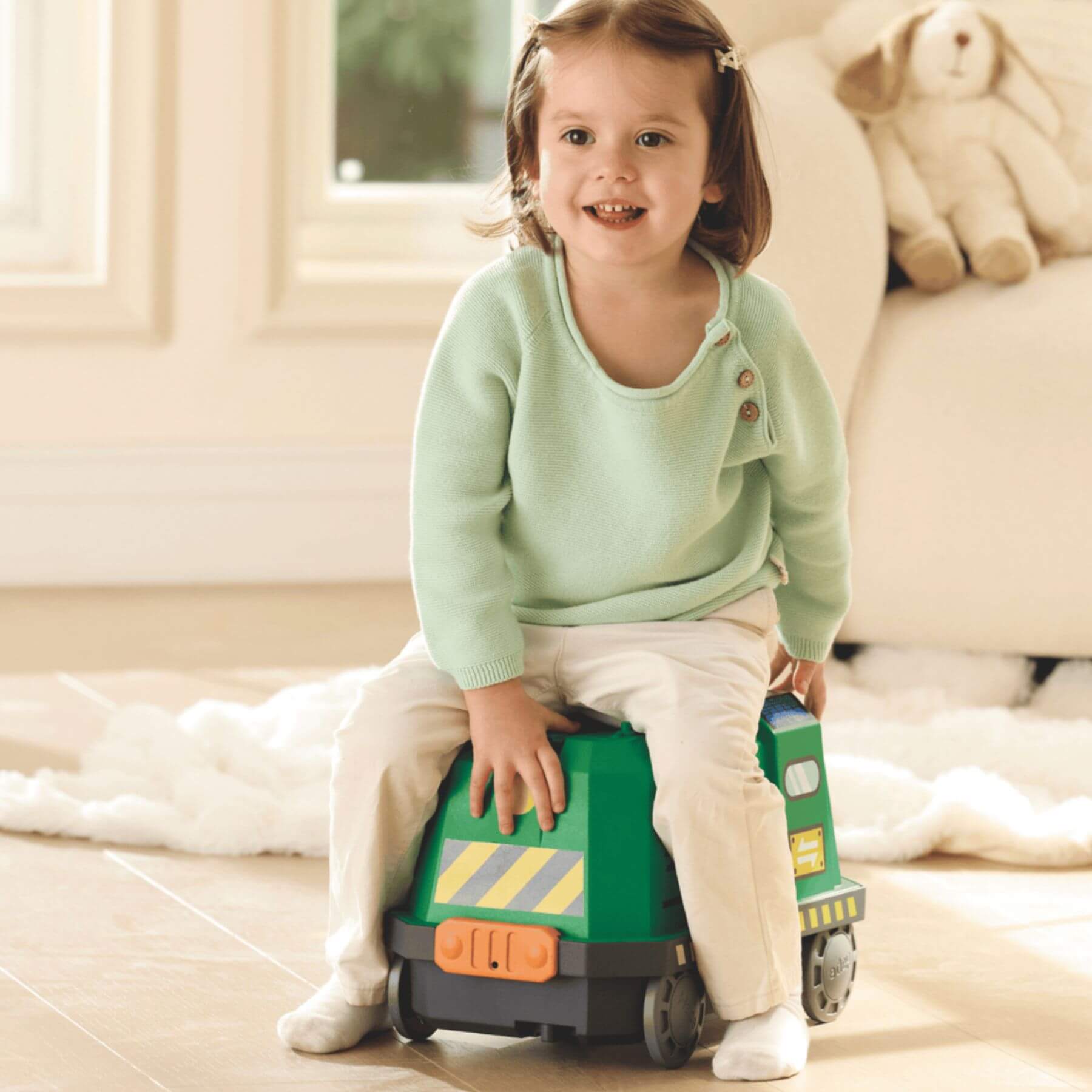 Child sitting onHape Eco Energy Train Bucket Set indoors