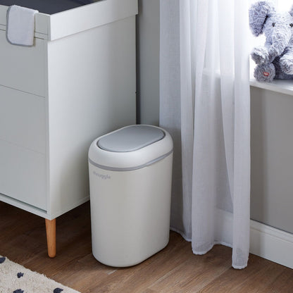 Shnuggle Eco-Touch Nappy Bin Diaper Pail in a room with a crib and stuffed toys.