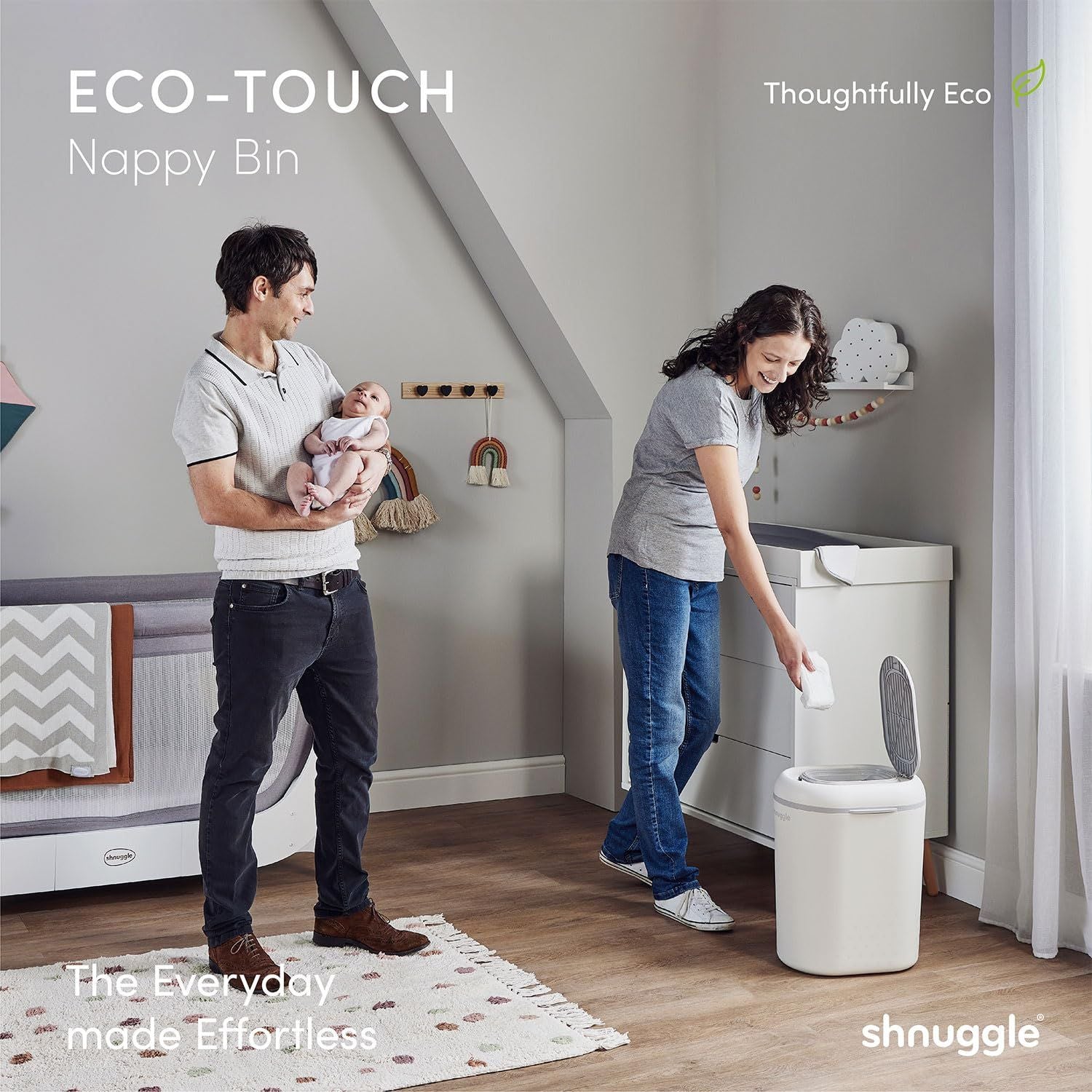 Family in a nursery with an ECO-TOUCH nappy bin, featuring 'shnuggle' branding.