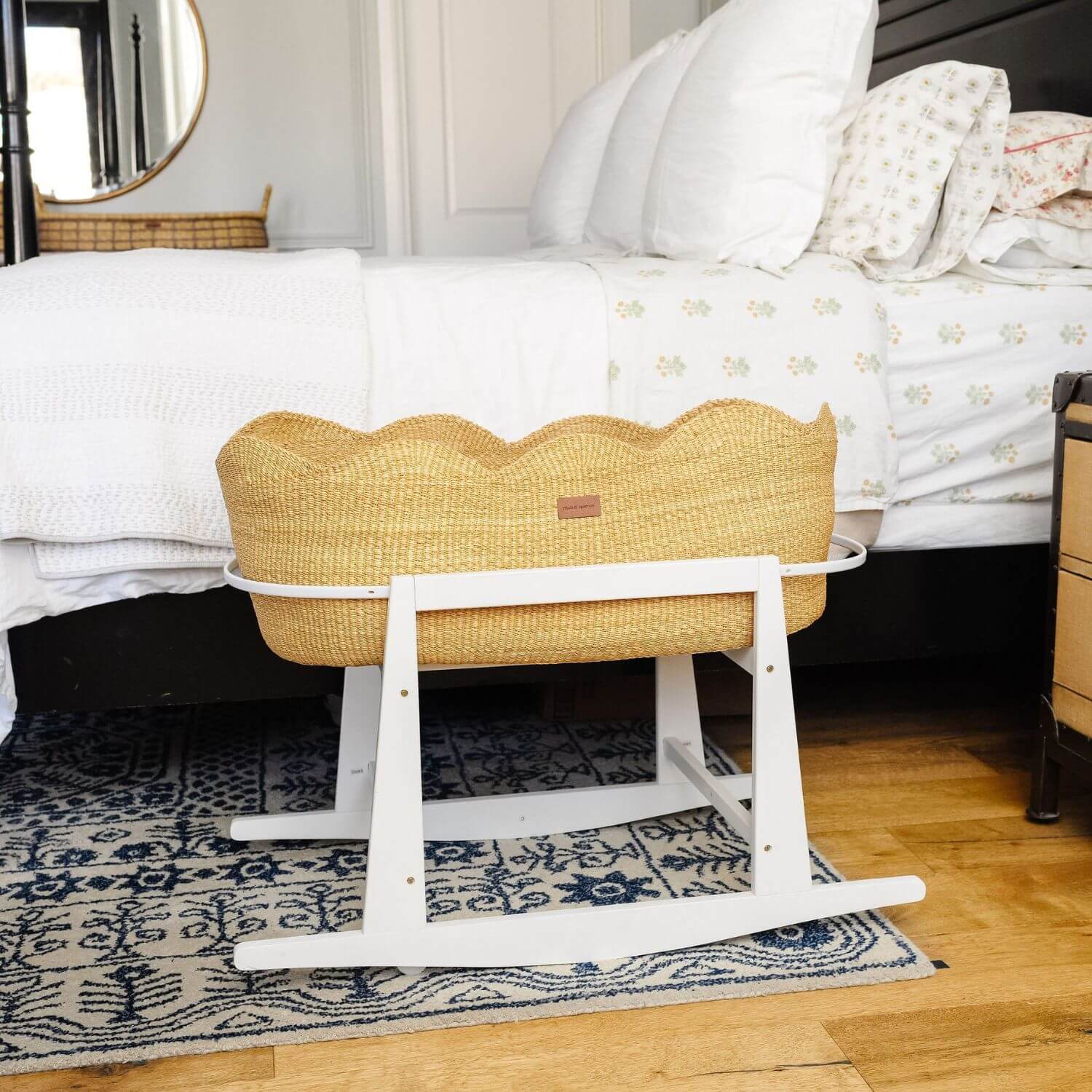 Elaine Bassinet with white stand in a bedroom setting